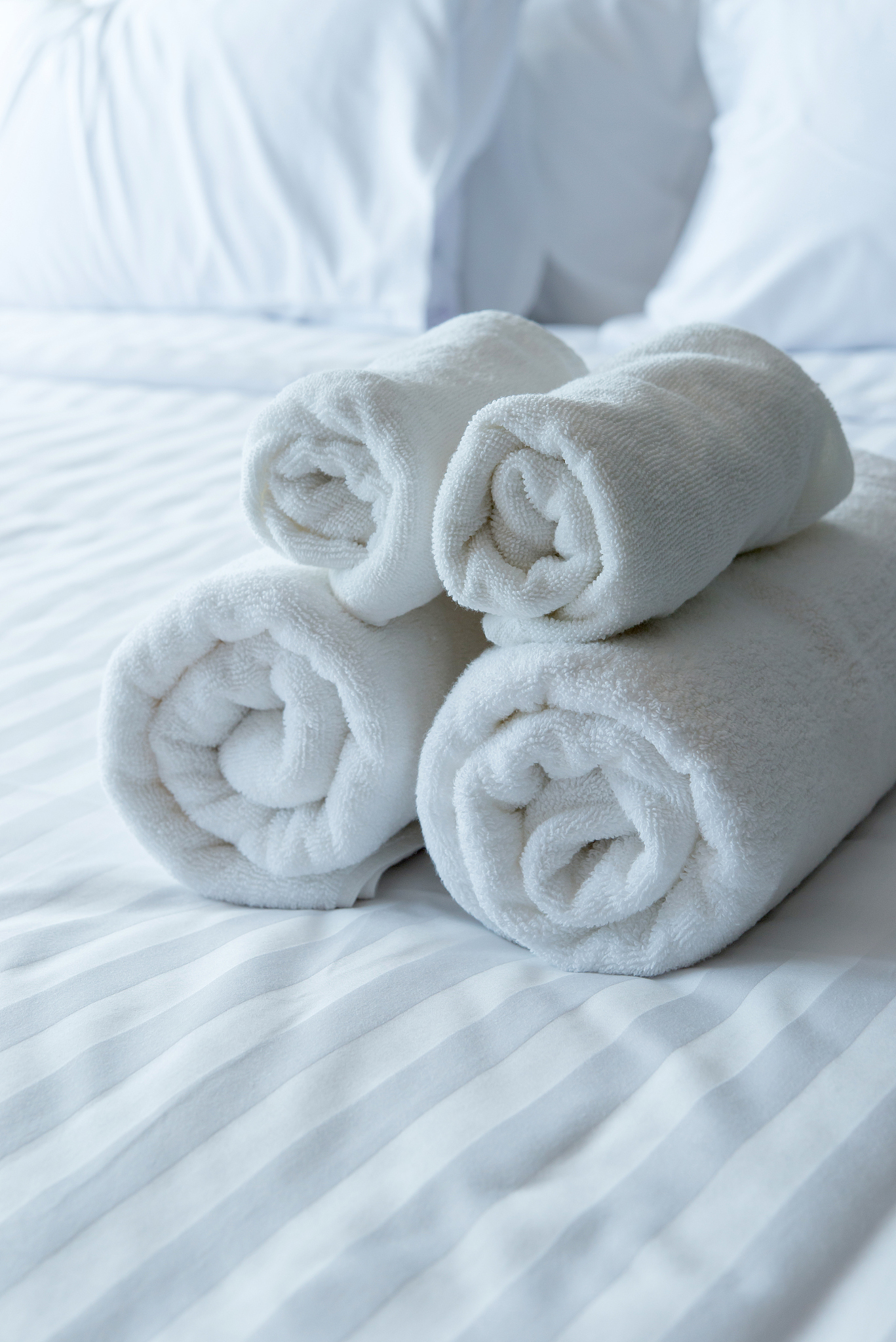 white bath towels in bed room, room service