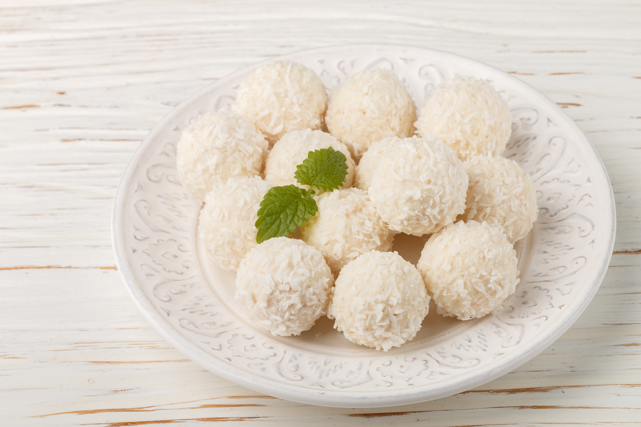 homemade coconut candies closeup on white wooden background. sel