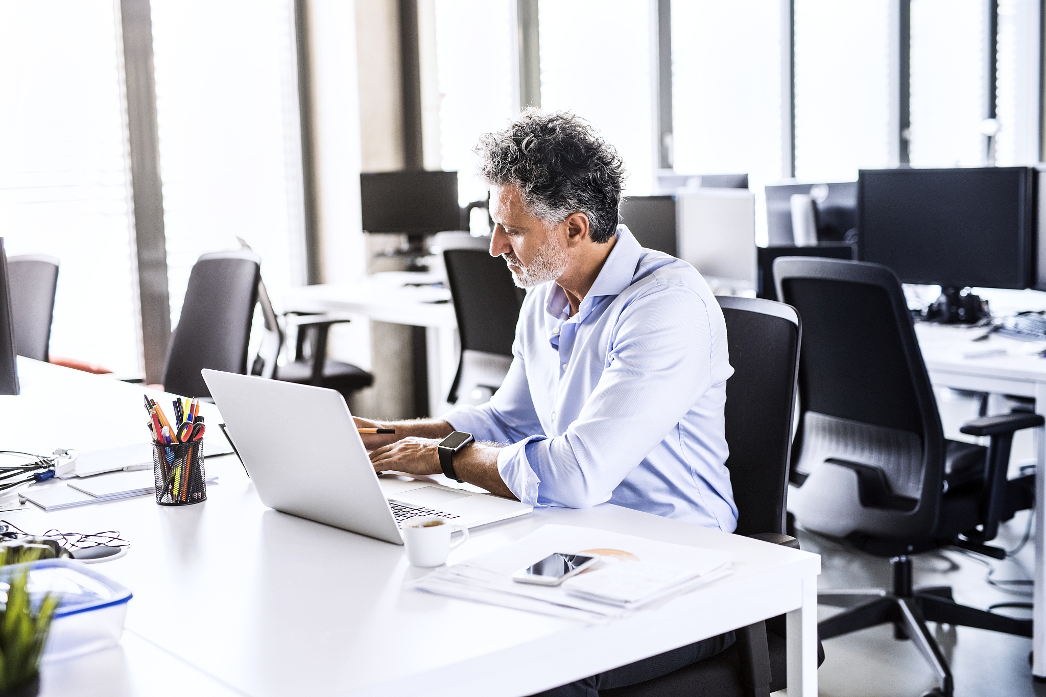 mature businessman working at desk in office