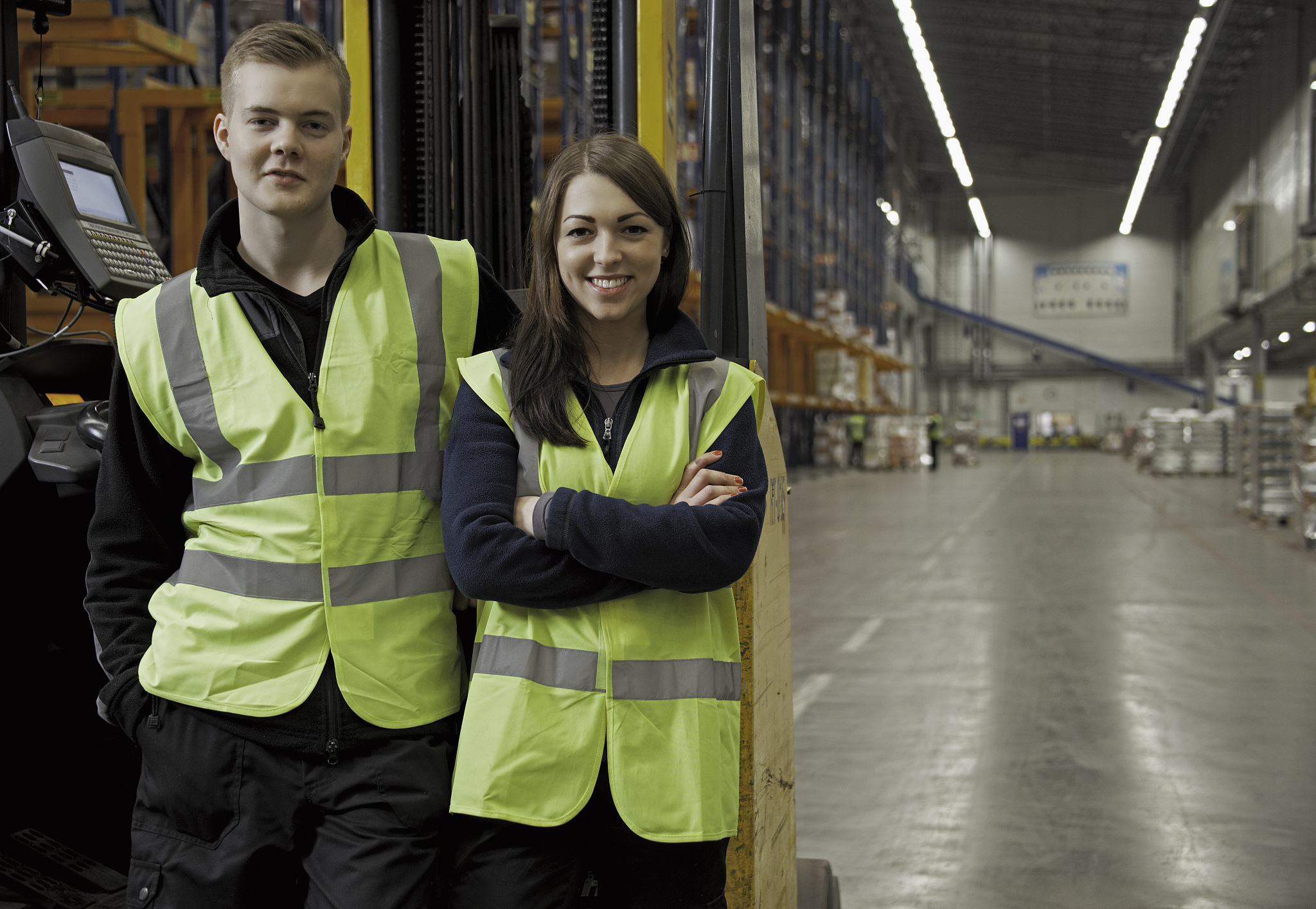 workers by forklift in warehouse