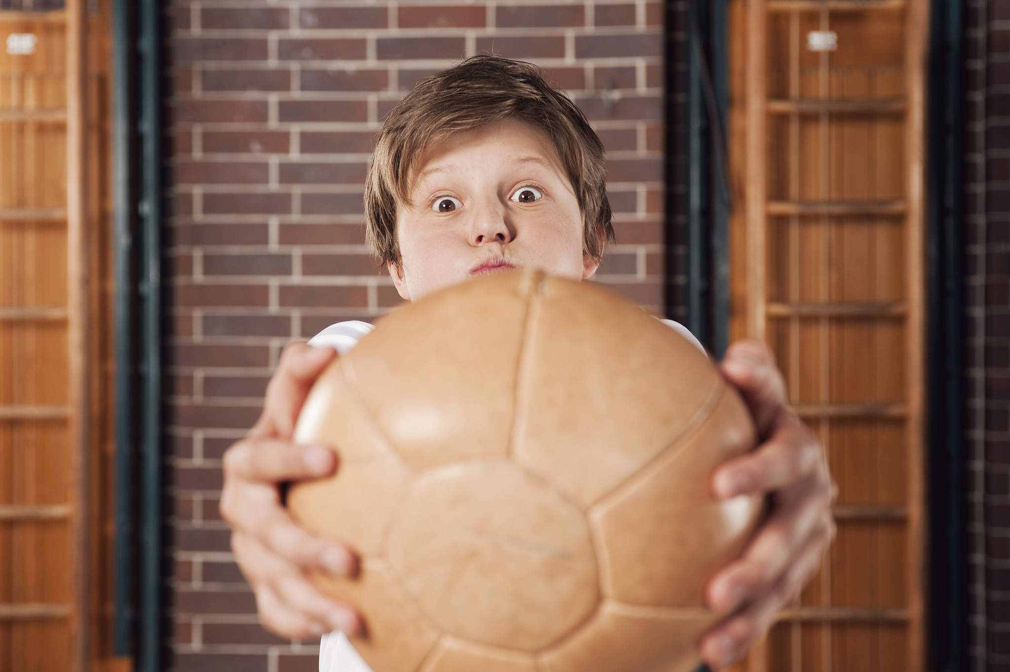 boy lifting medicine ball