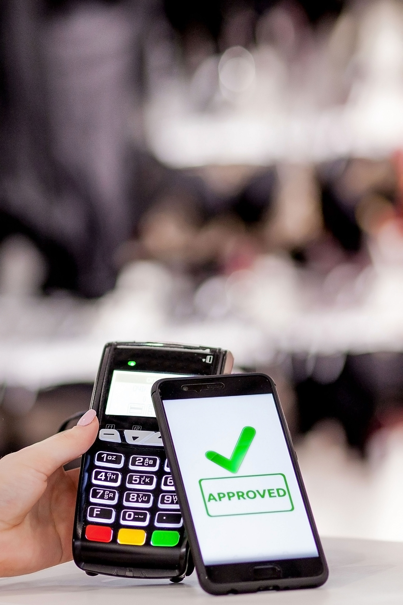 pos terminal, payment machine with mobile phone on store backgro