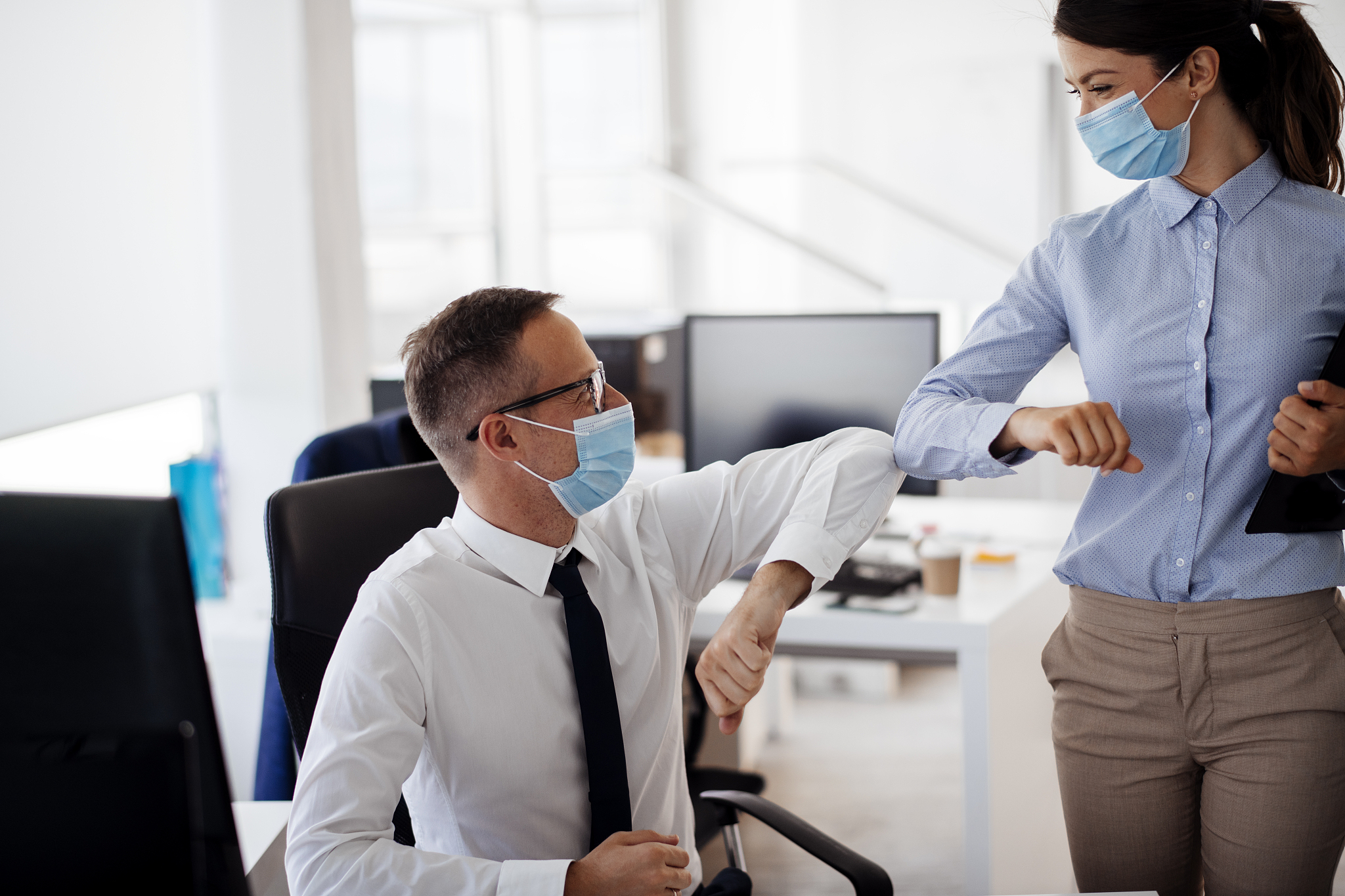business people greeting during covid-19 pandemic stock photo