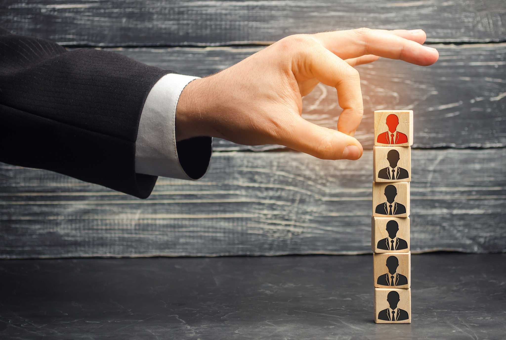the businessman removes / dismisses the employee from the team. 