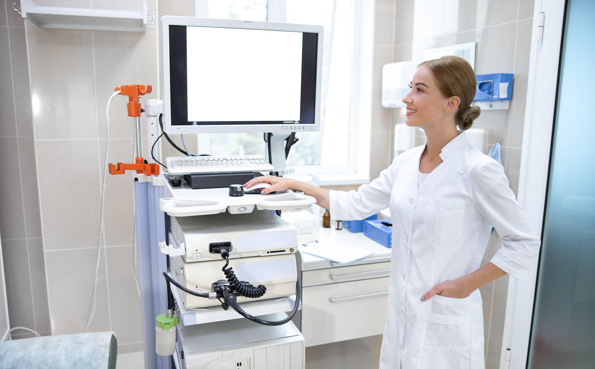 young woman working with ultrasound machine stock photo