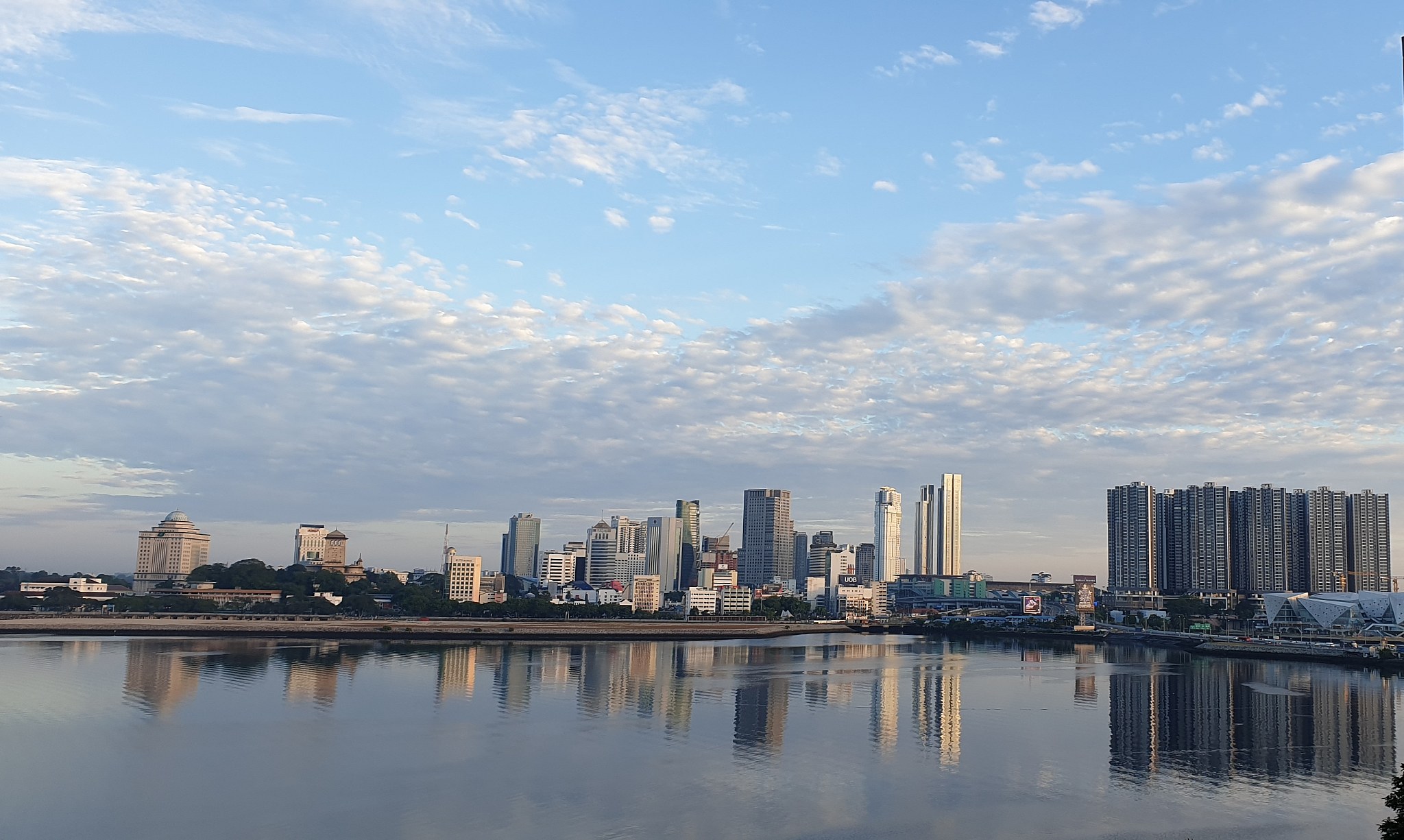 scenic view of river and buildings against sky