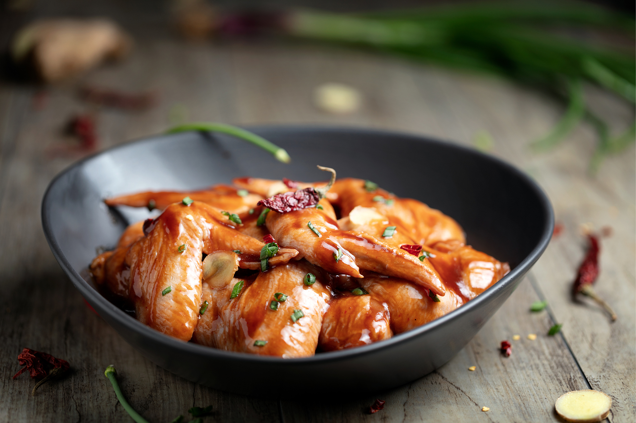 raw marinated chicken wings for bbq, with green onion and dry re