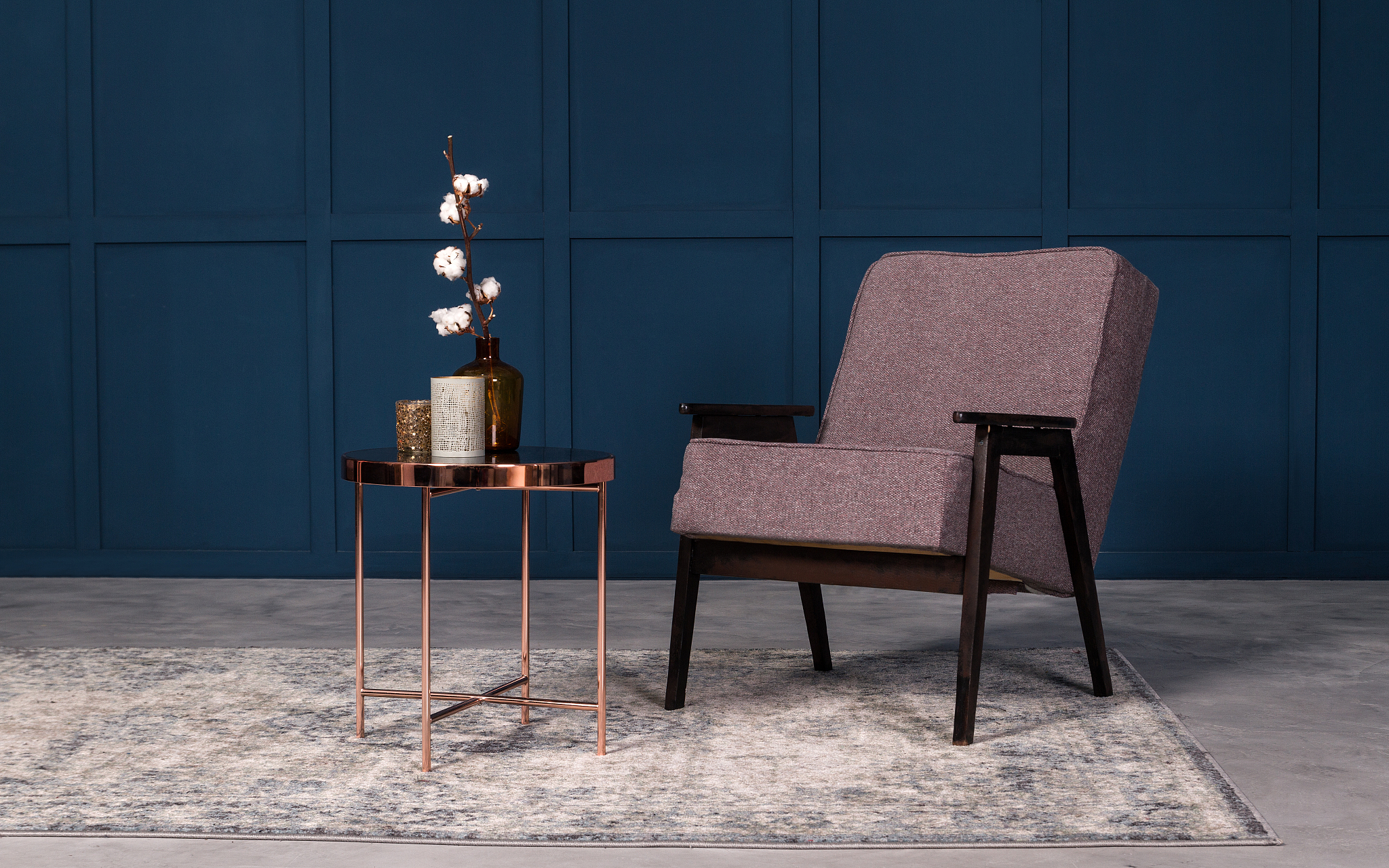 modern armchair with copper coffee table and table accessories