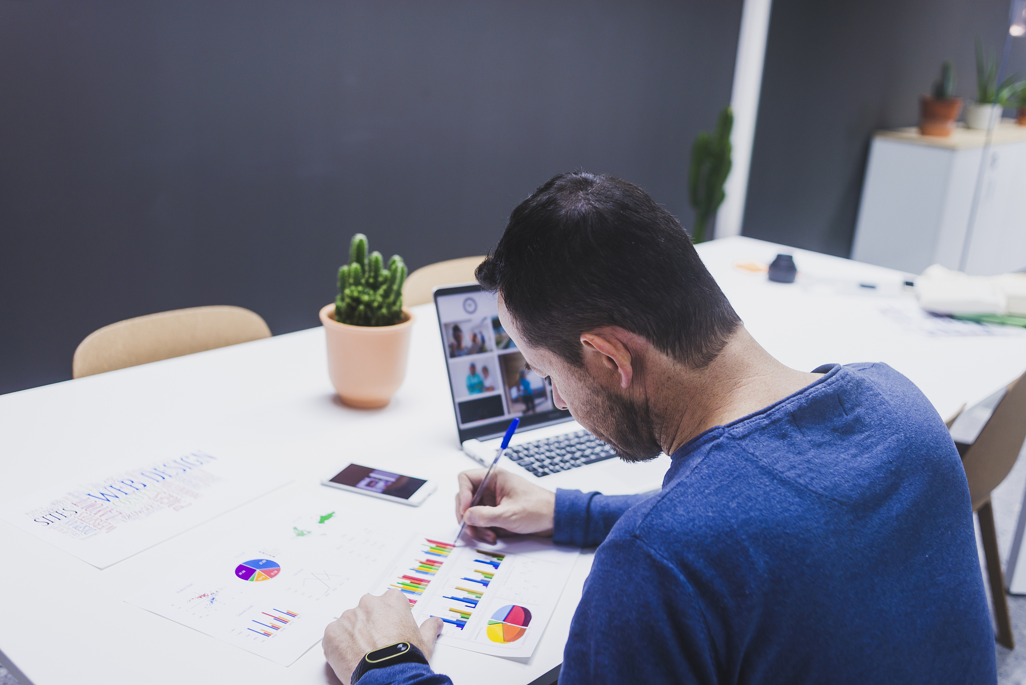 man working on documents at desk in office