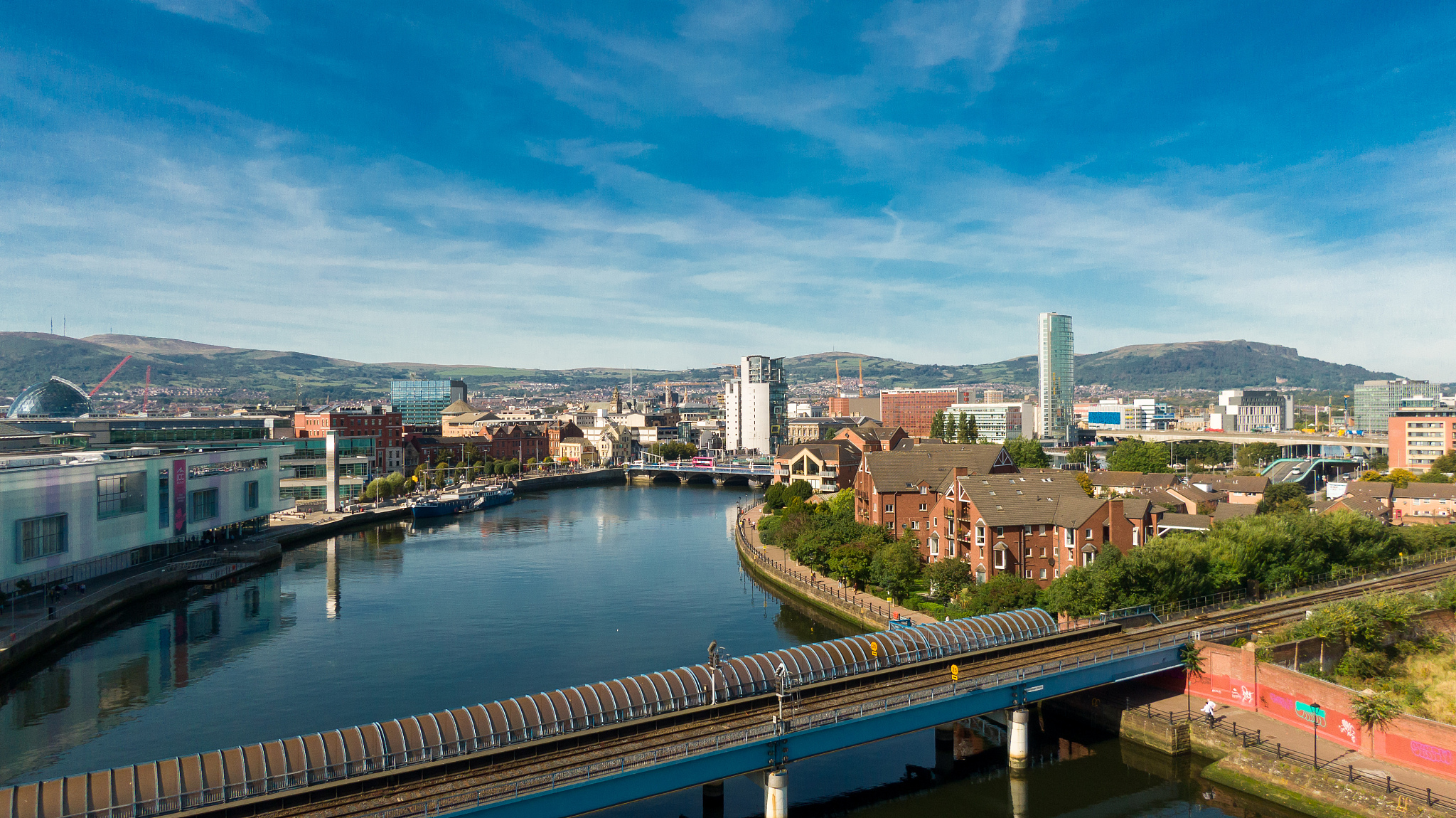 high angle view of river amidst buildings in city against sky