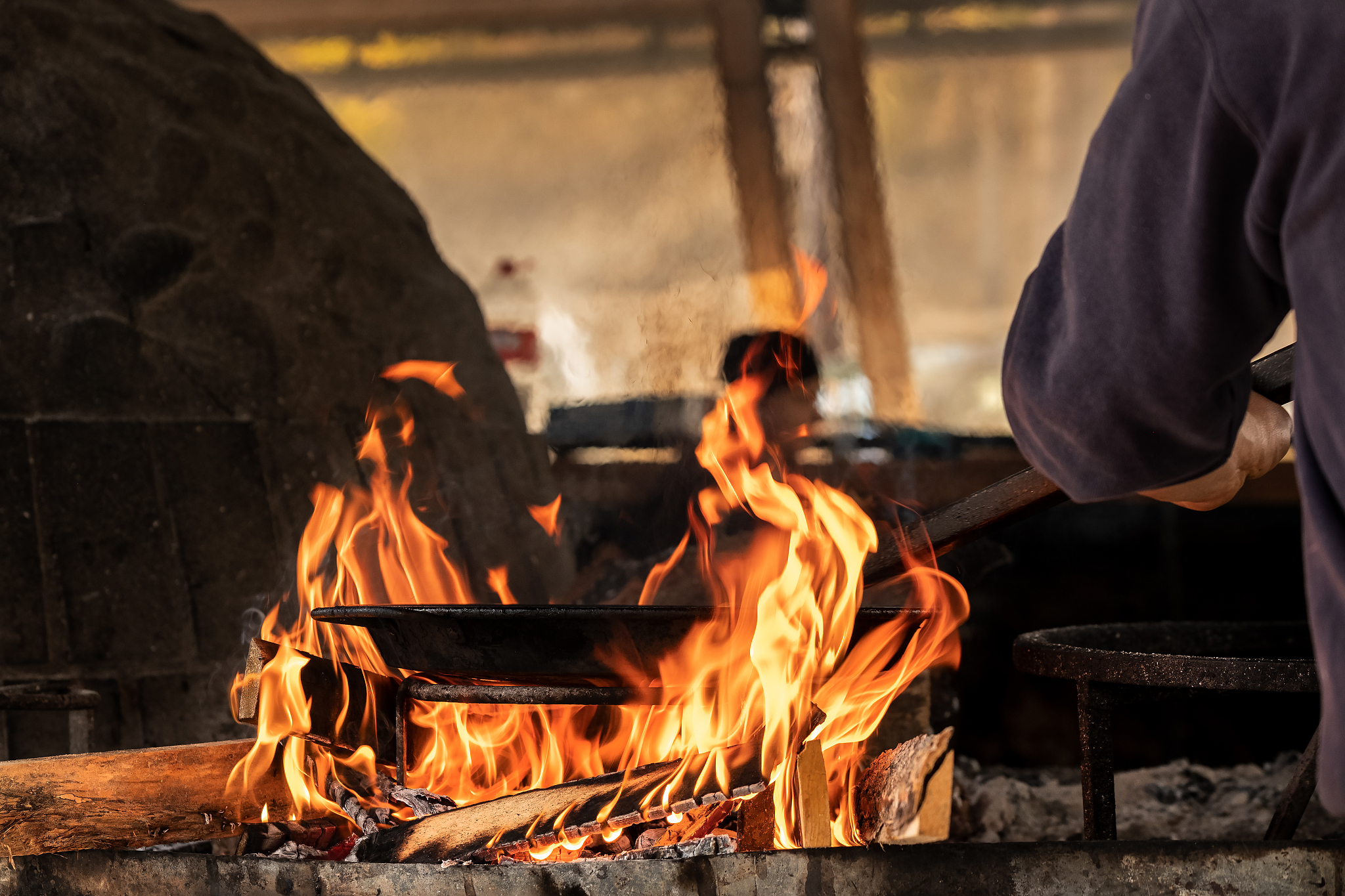 cropped image of worker working at fire
