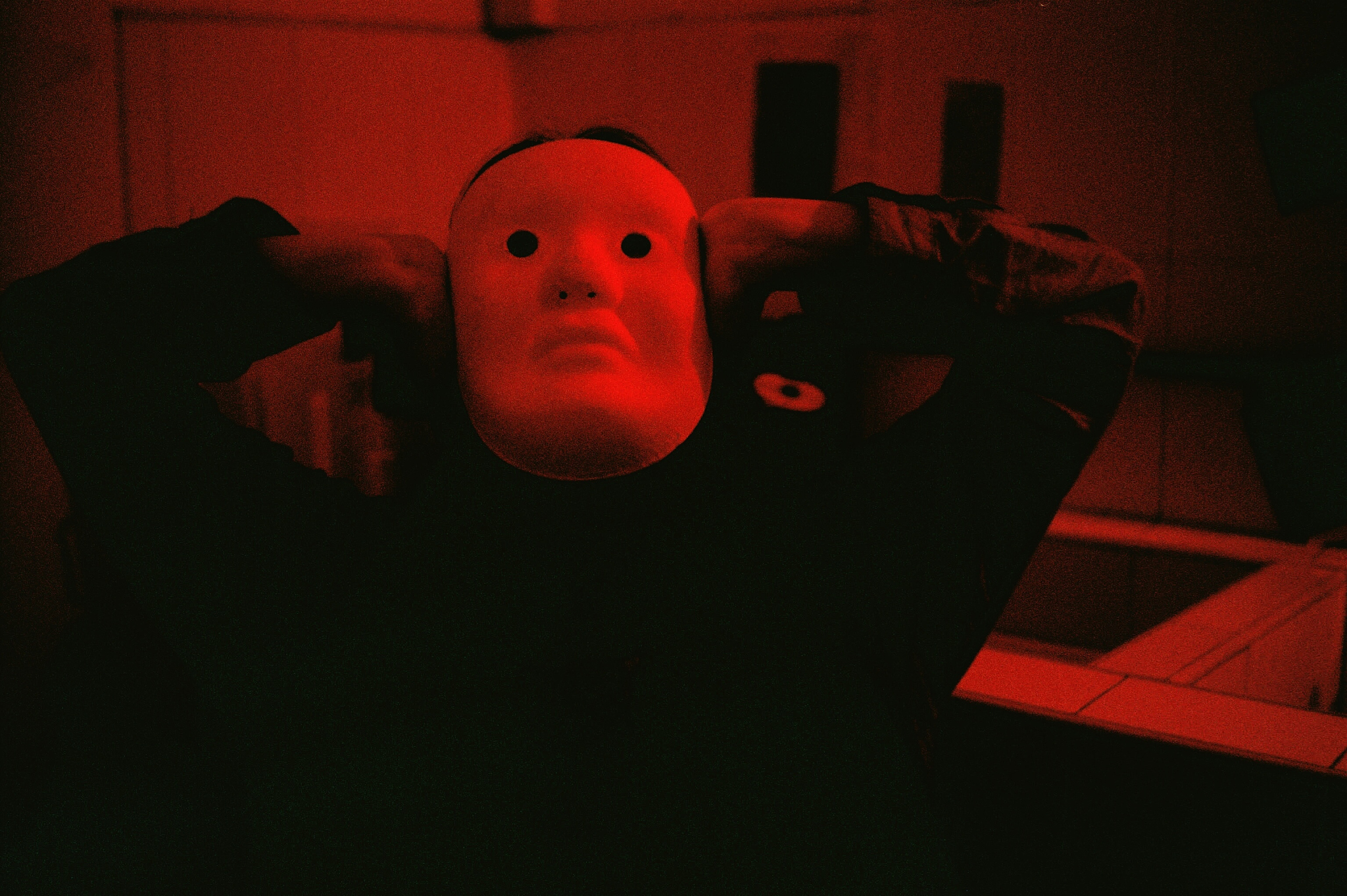 person wearing mask in darkroom