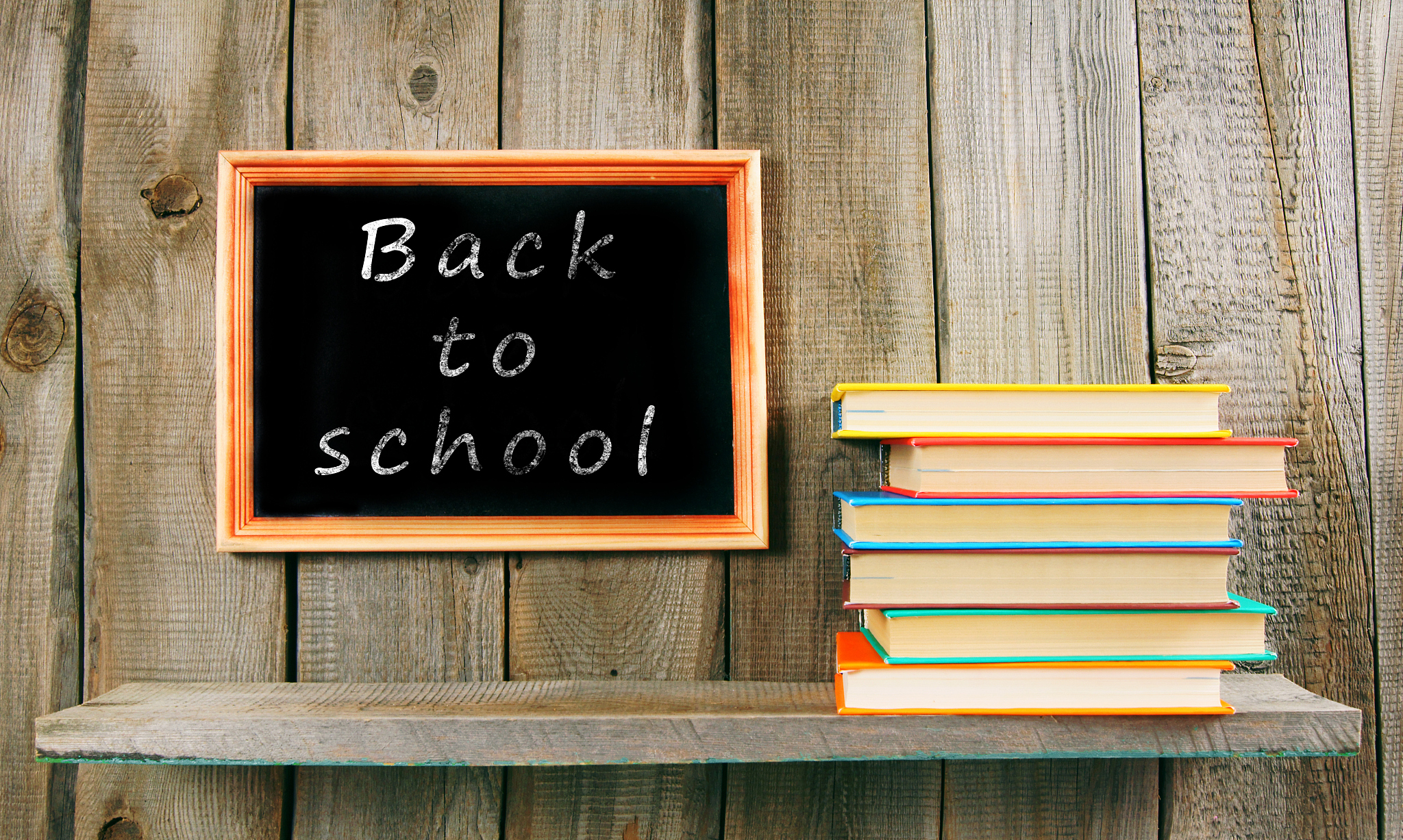 back to school. books on wooden background.