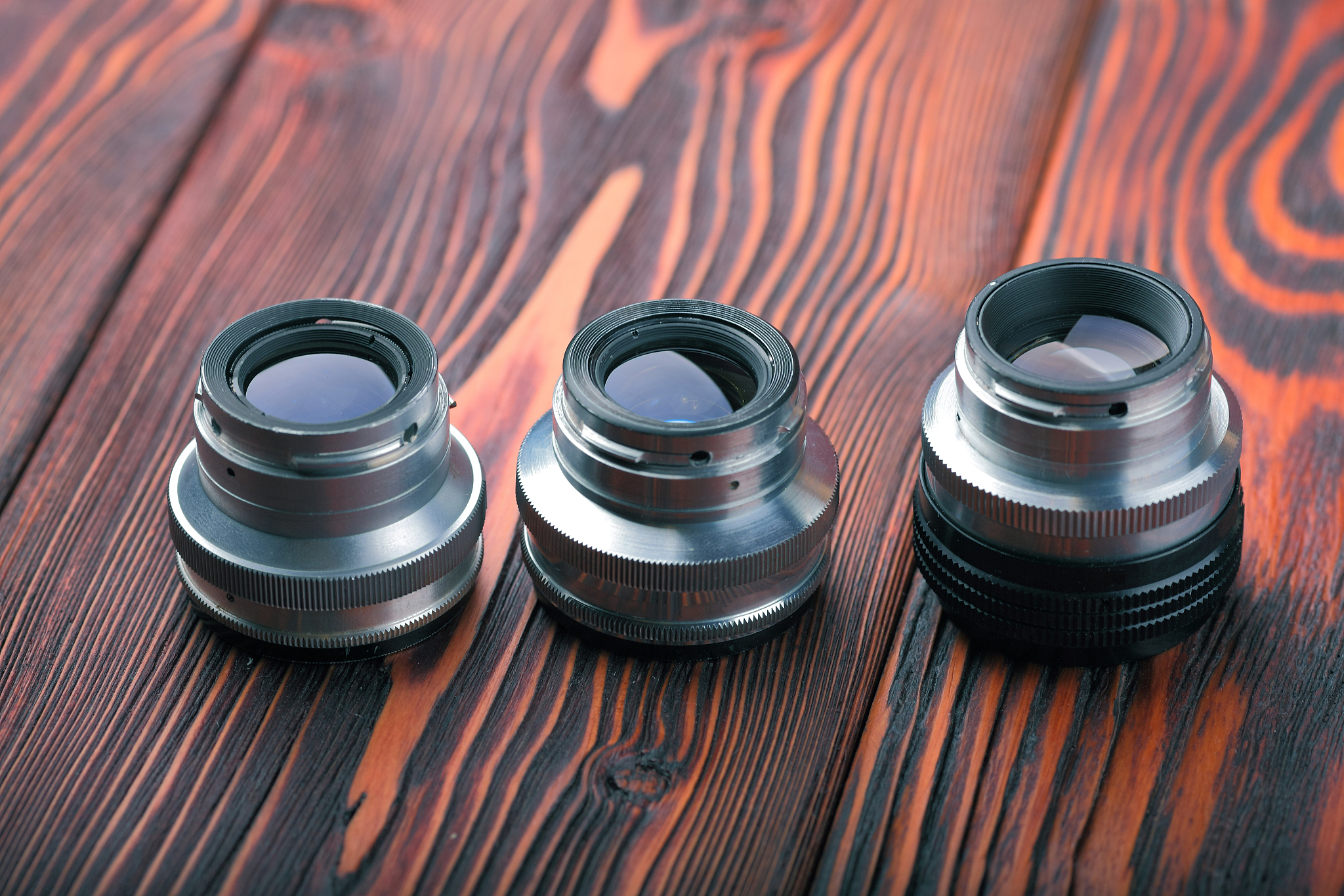 old lens from film camera on the wooden table