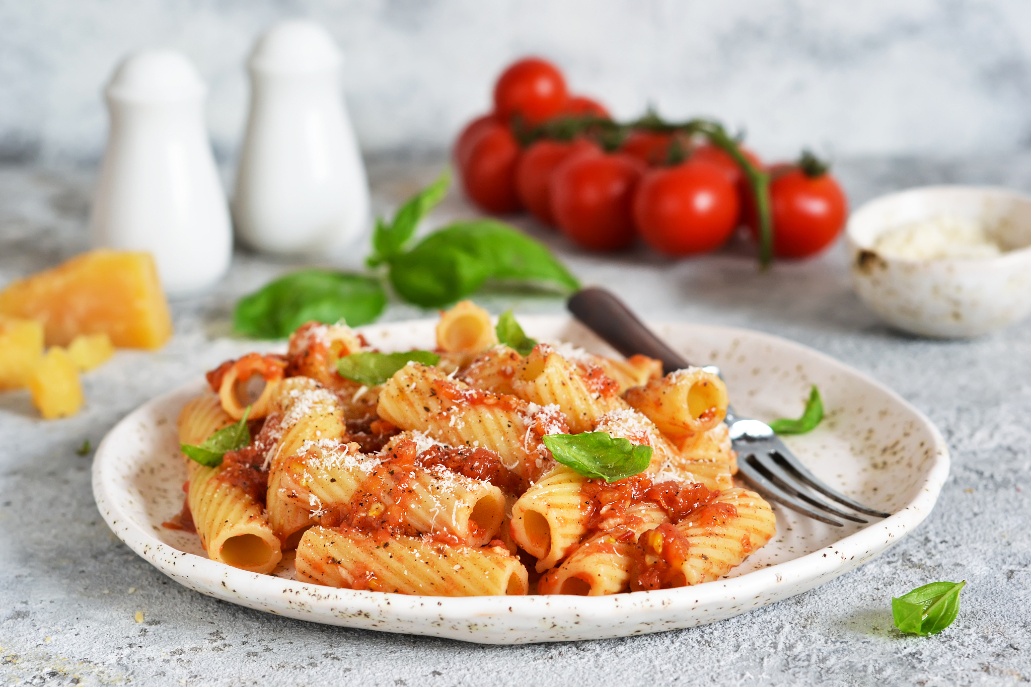 pasta with tomato sauce and basil. pasta tartilloni on a dark ba
