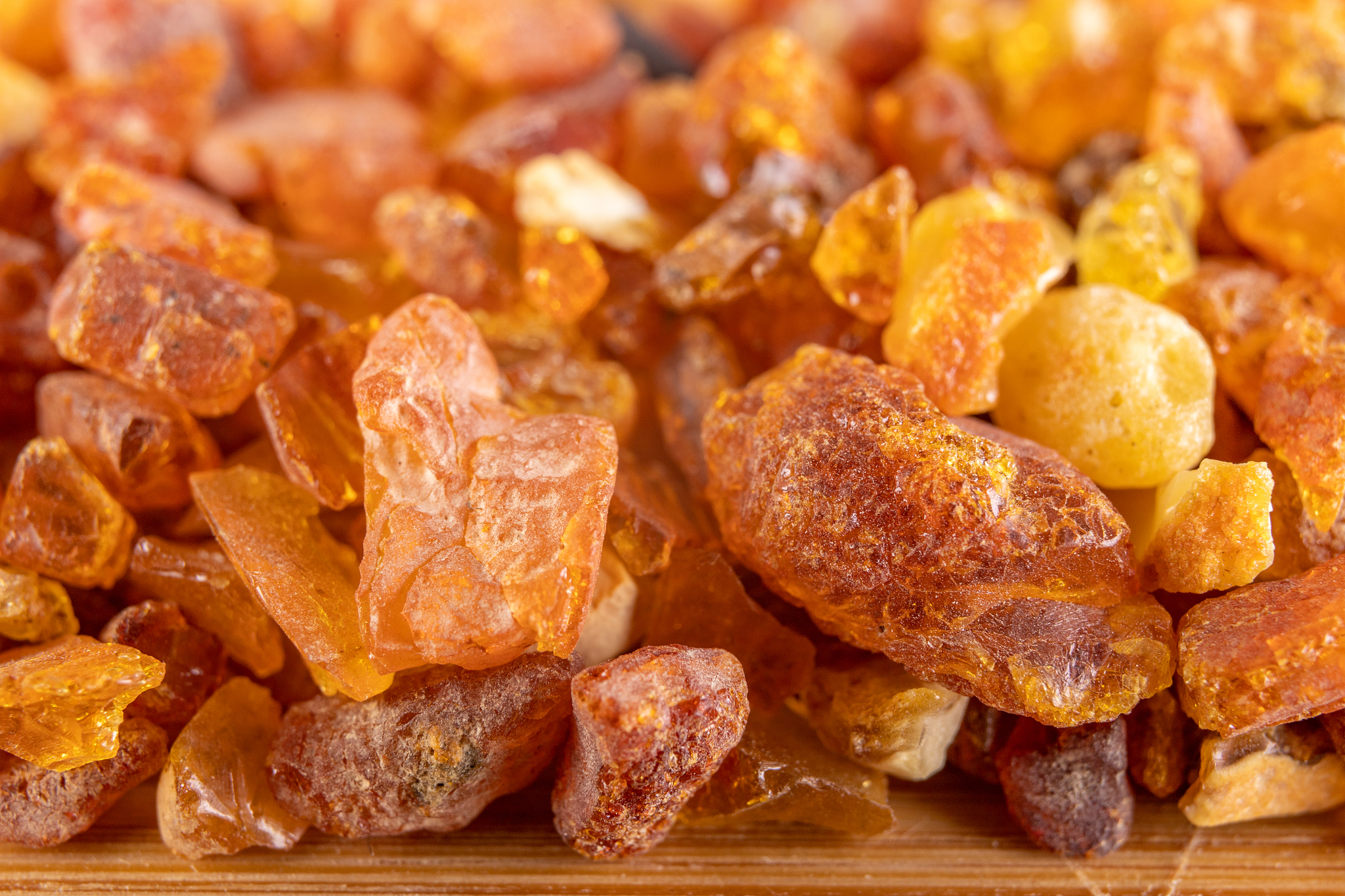 raw small pieces of amber arranged on a wooden board. precious p