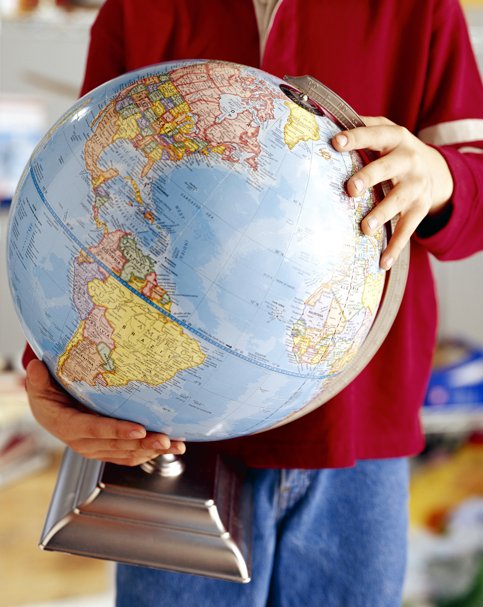 hands of boy holding globe