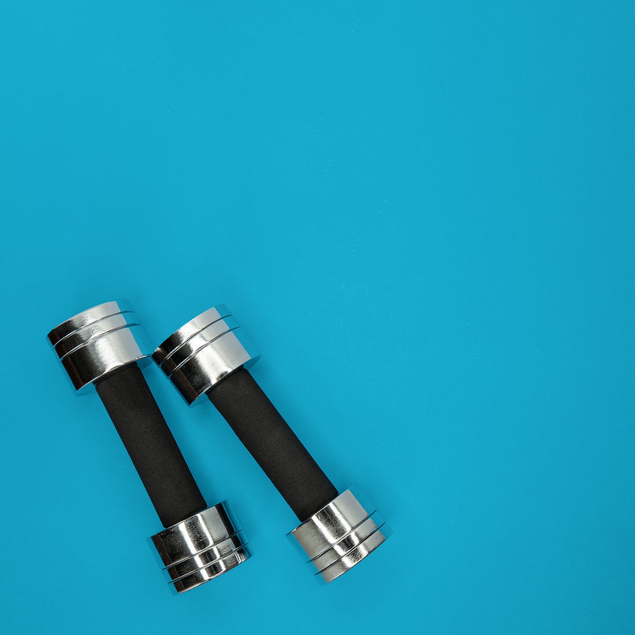 metal small dumbbells on a blue background.
