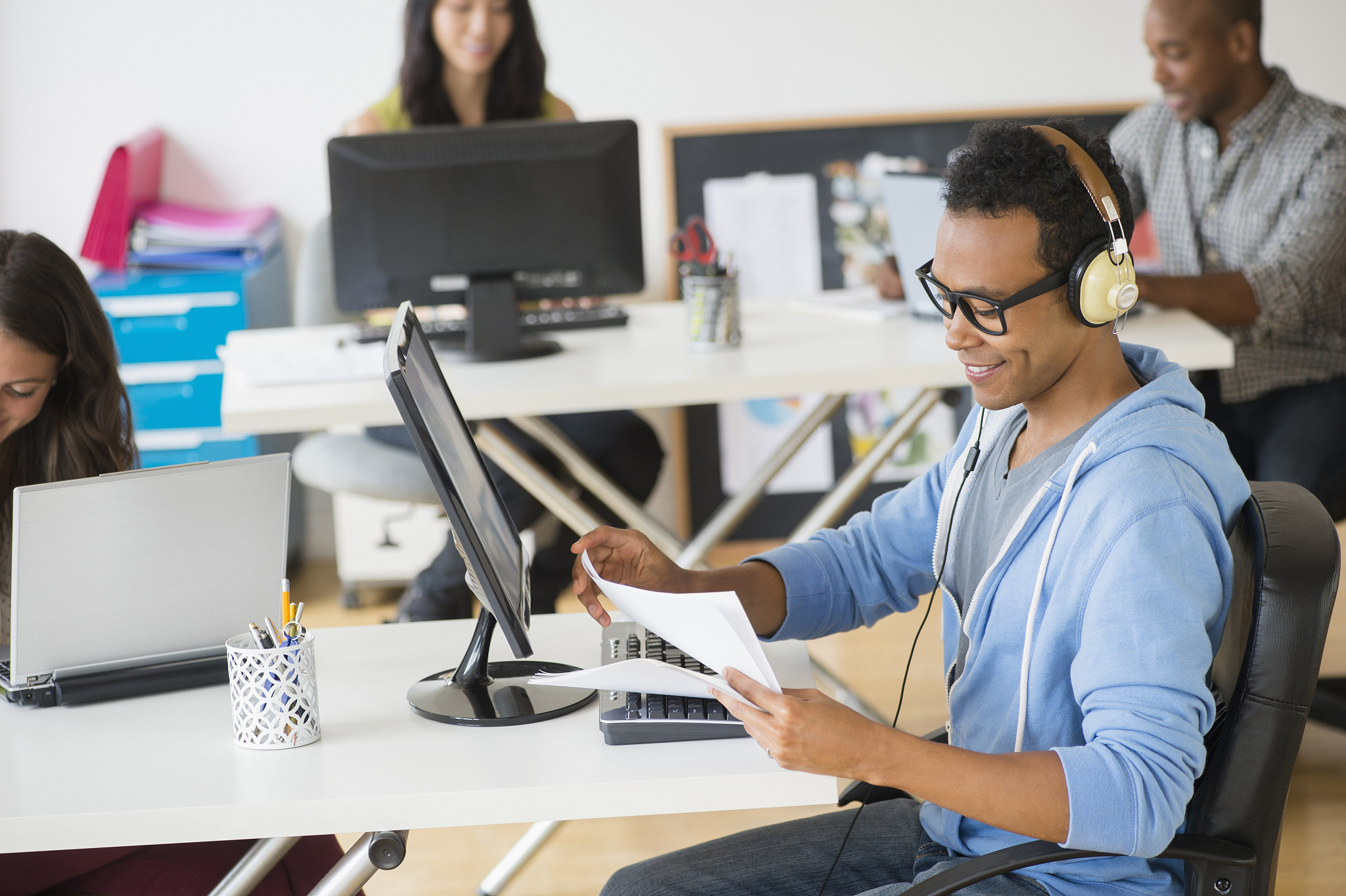 businessman listening to headphones and working in office