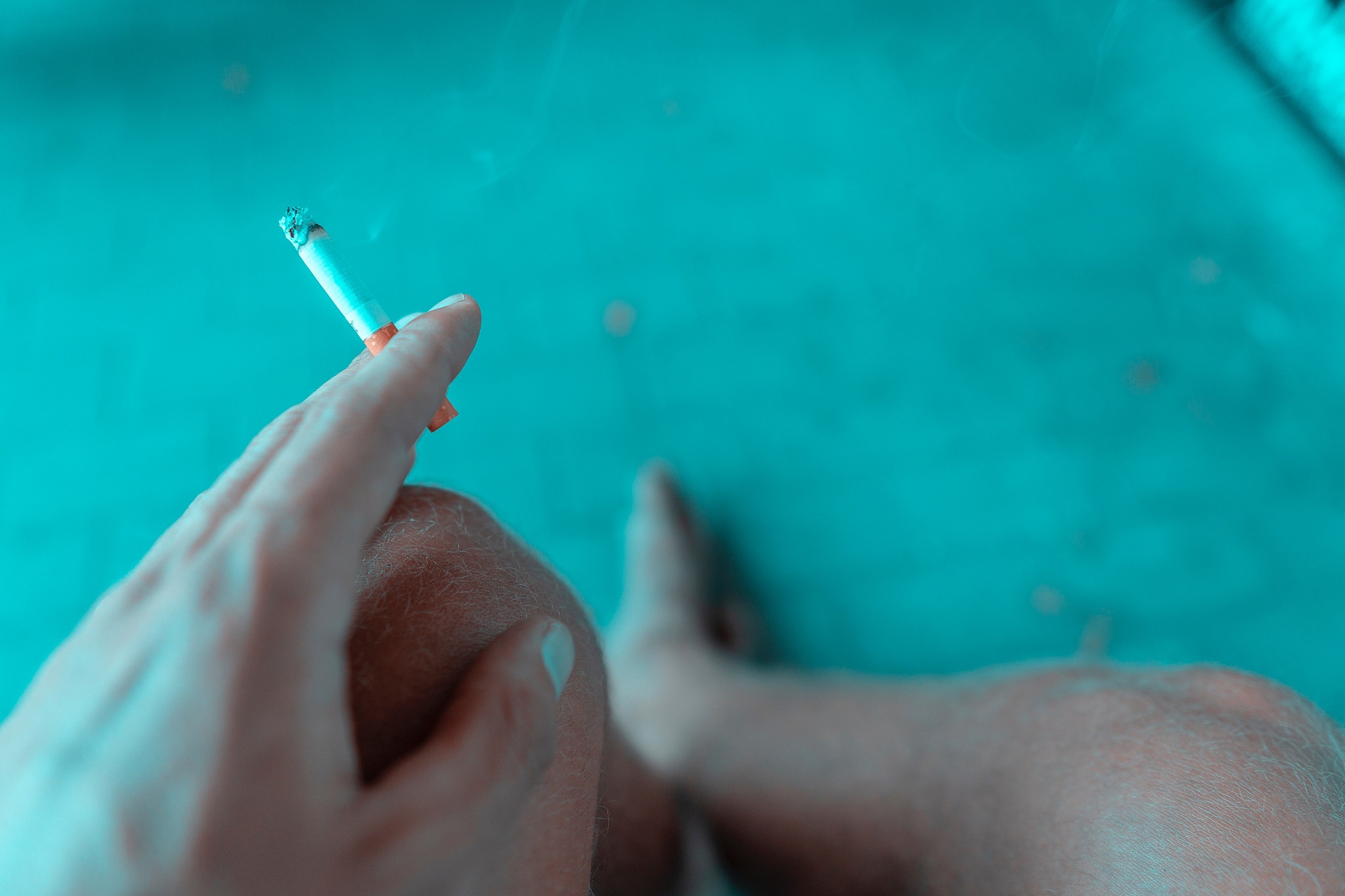 close-up of man smoking cigarette at home