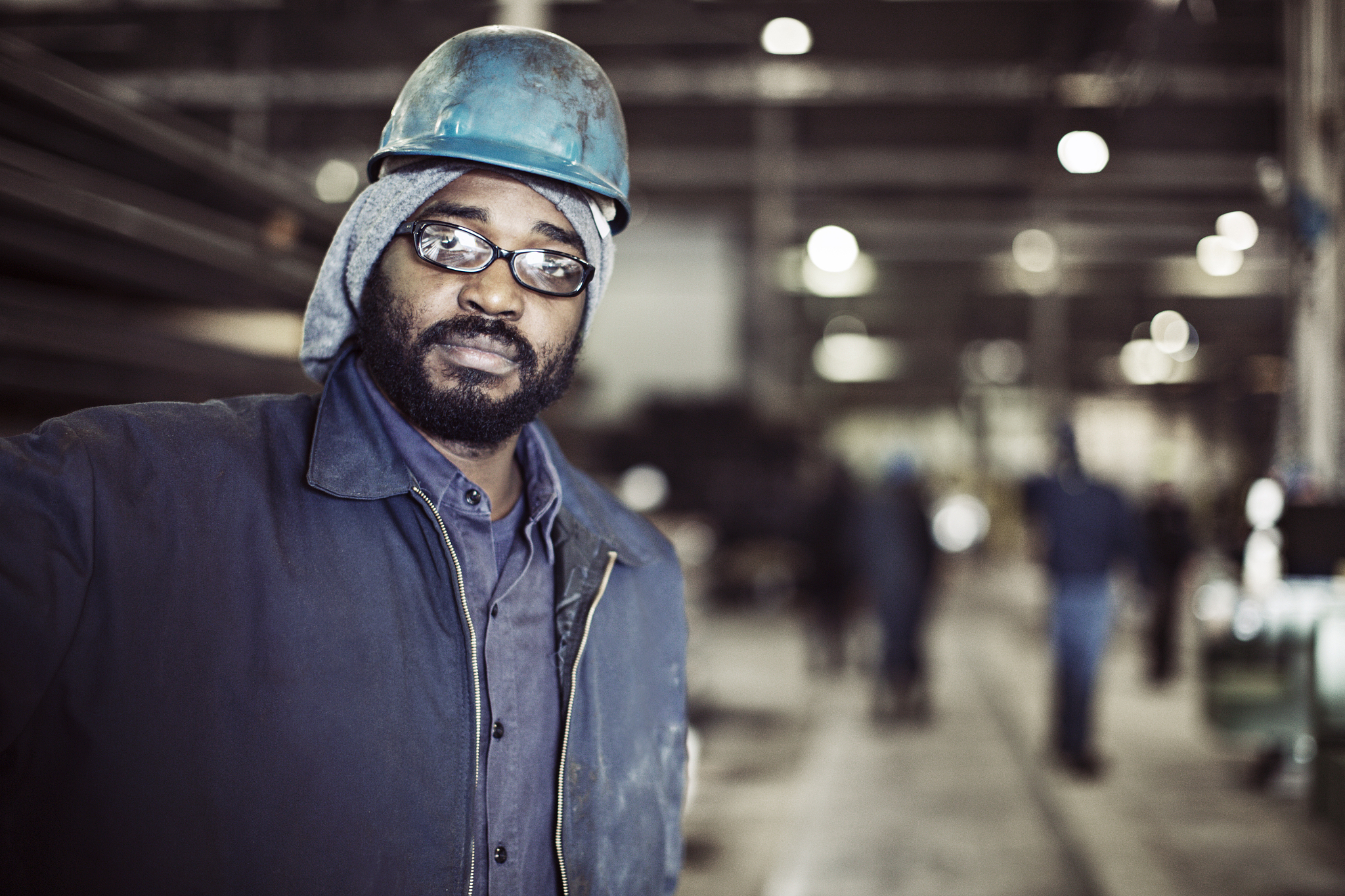 worker looking away while standing in factory