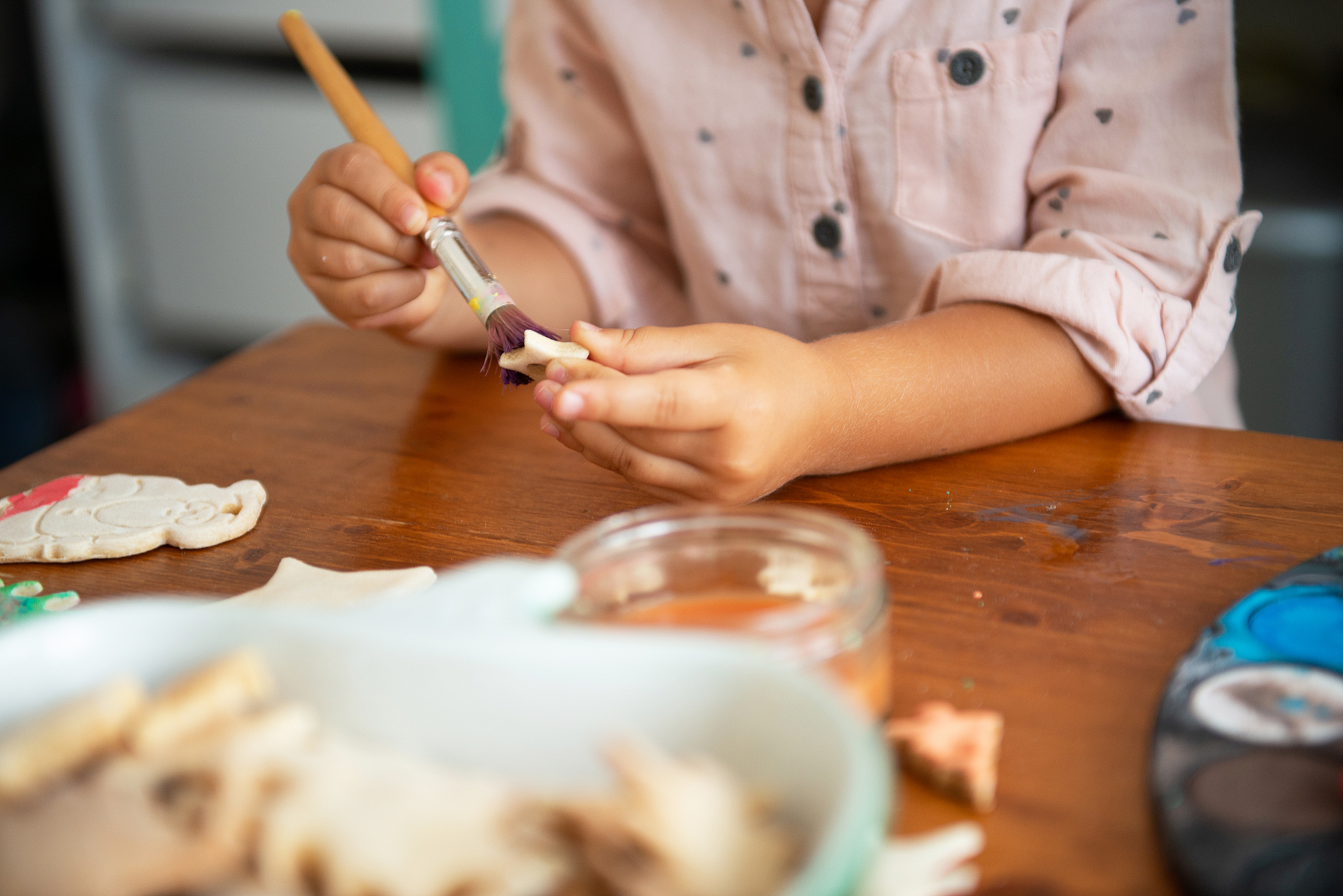 mother and daughter painting christmass ornaments