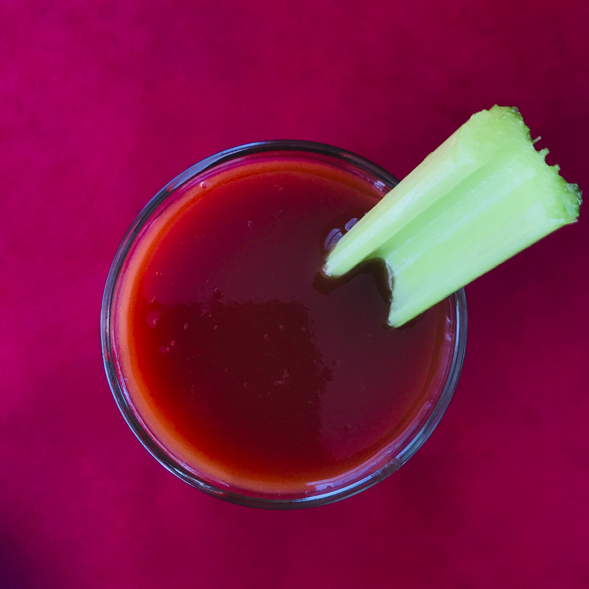 glass of tomato juice with celery
