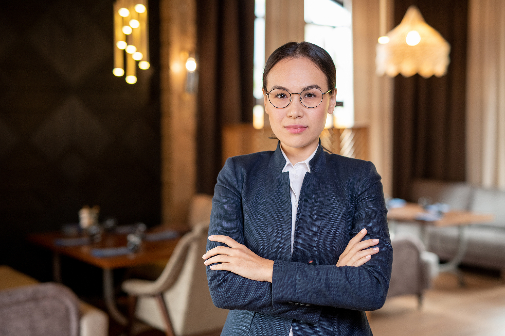 young contemporary asian woman in eyeglasses and formalwear in c