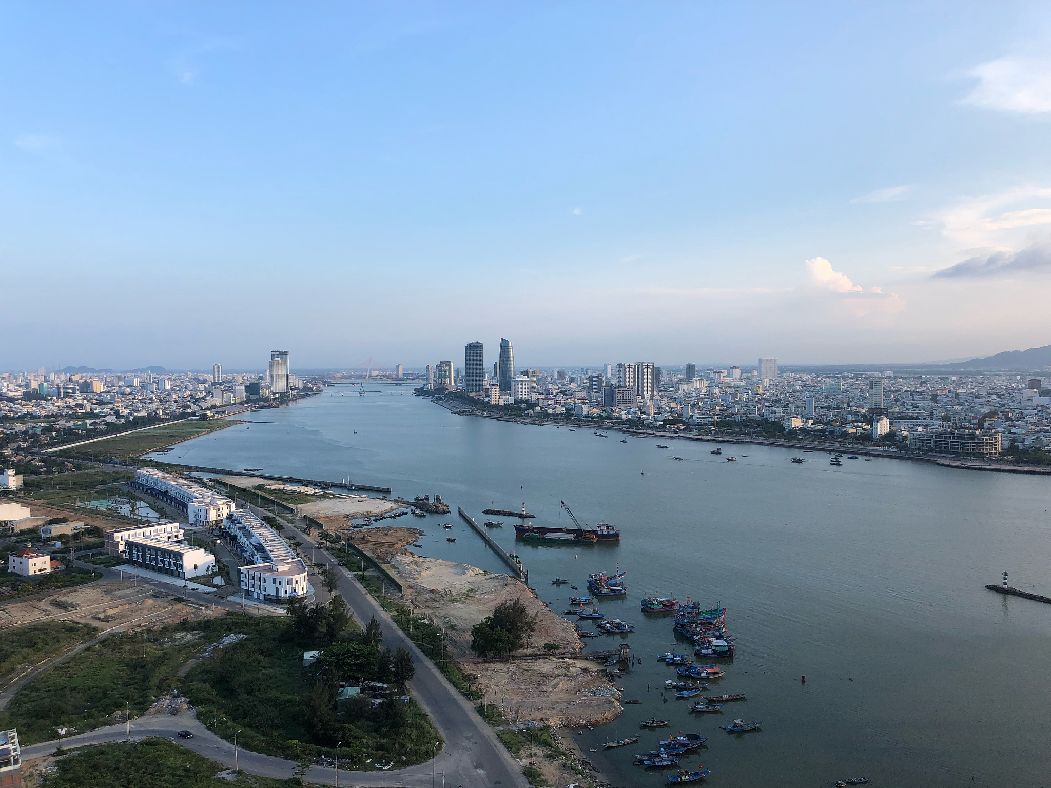 high angle view of buildings by sea against sky