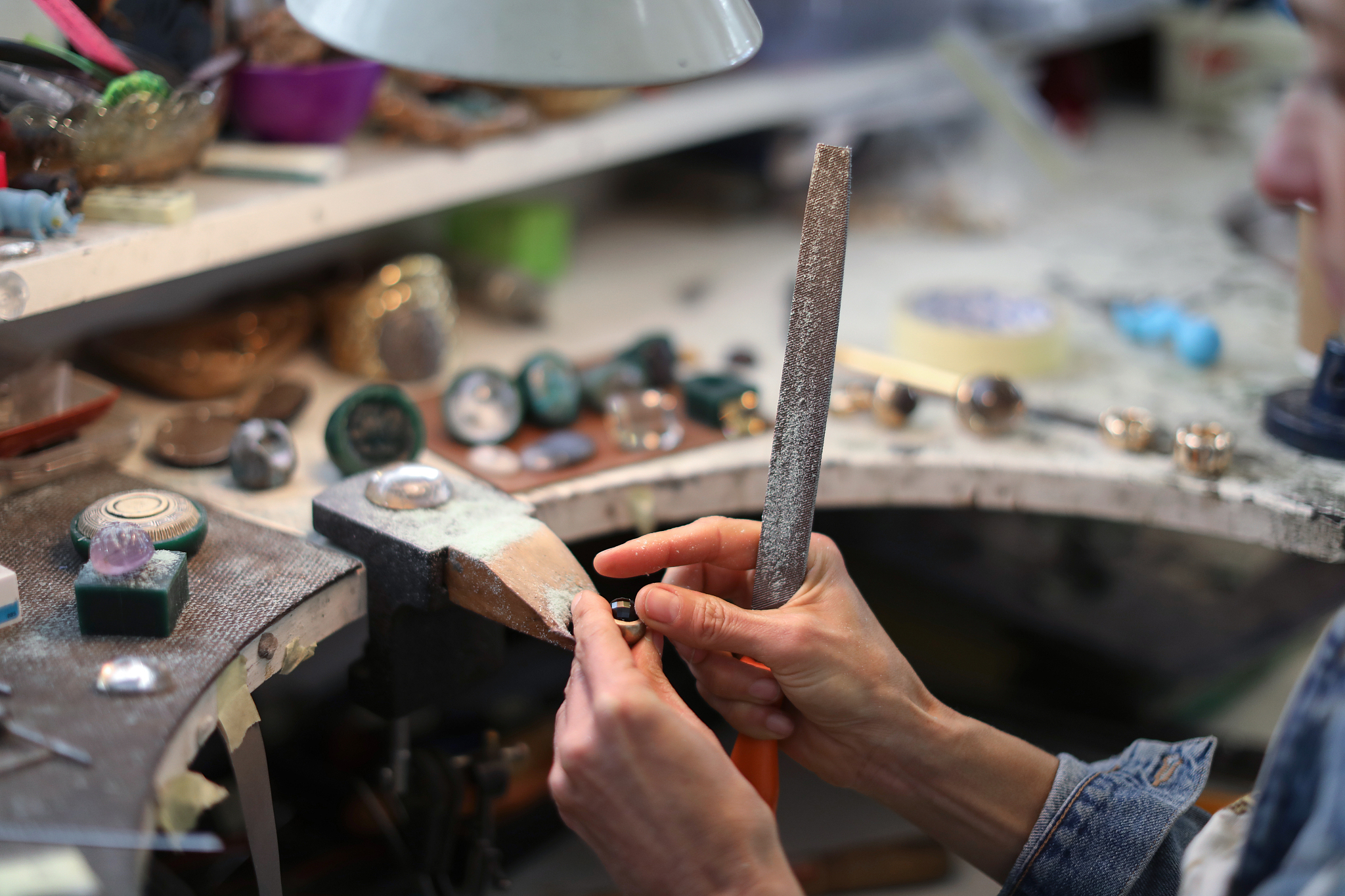 a jewellery designer working in her studio.