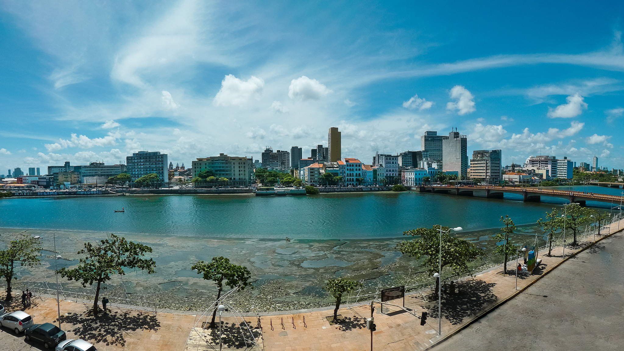 sea by buildings against sky in city