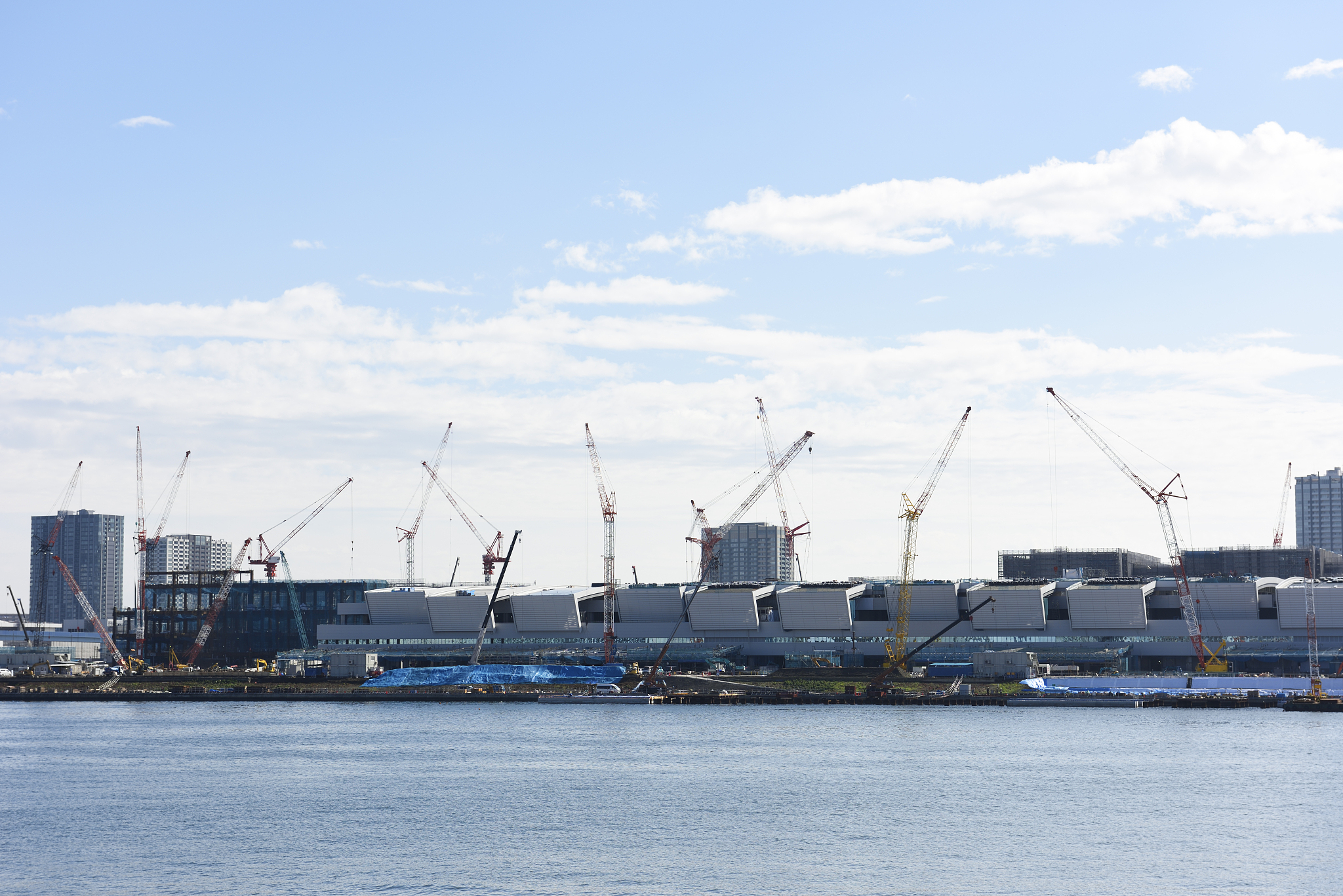 view from tokyo bay at construction site against blue sky