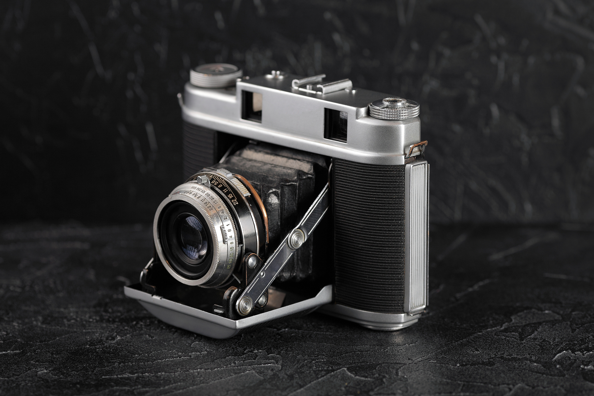the vintage medium format film camera on black cement background