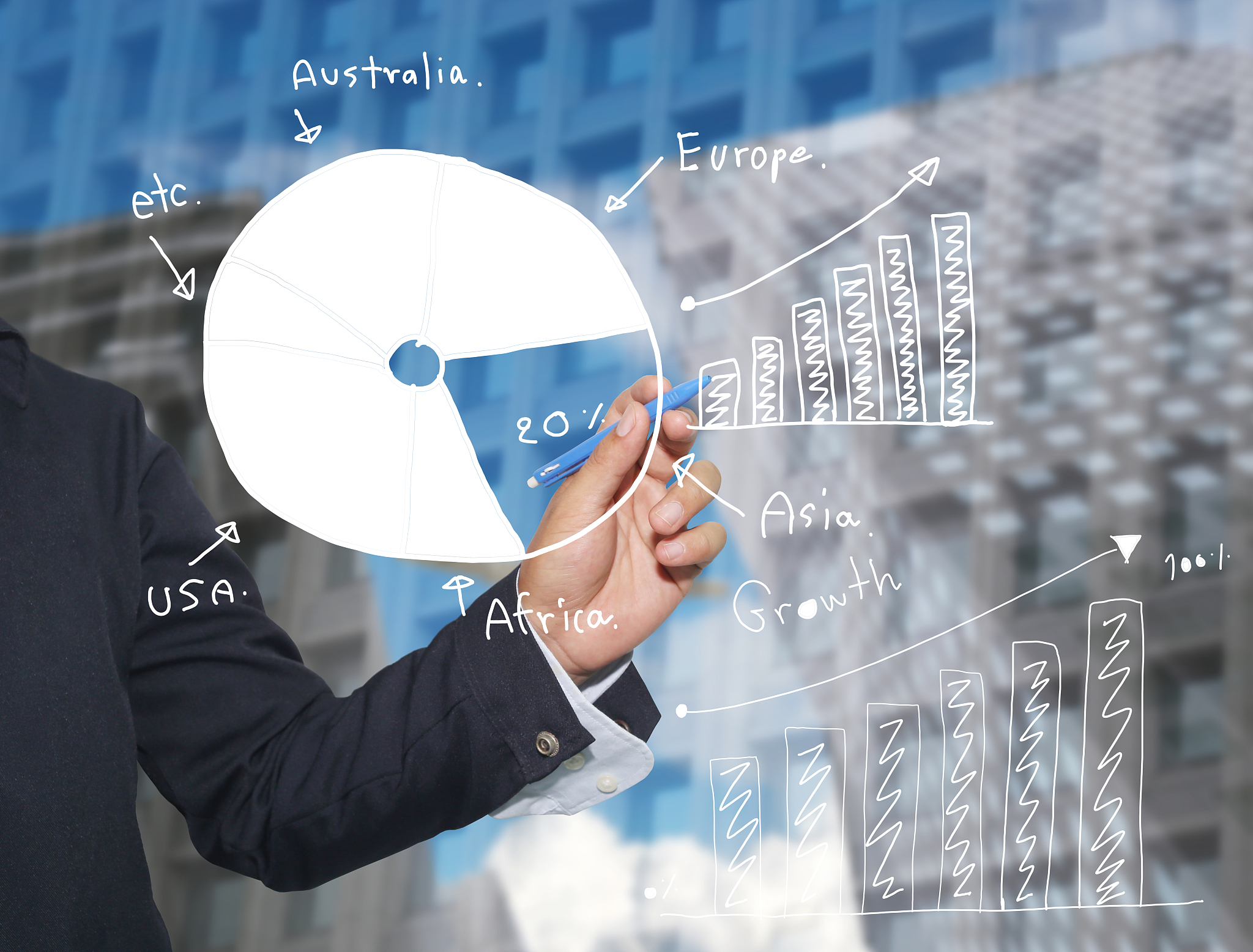hand of businessman drawing graphics a top point growing graph.