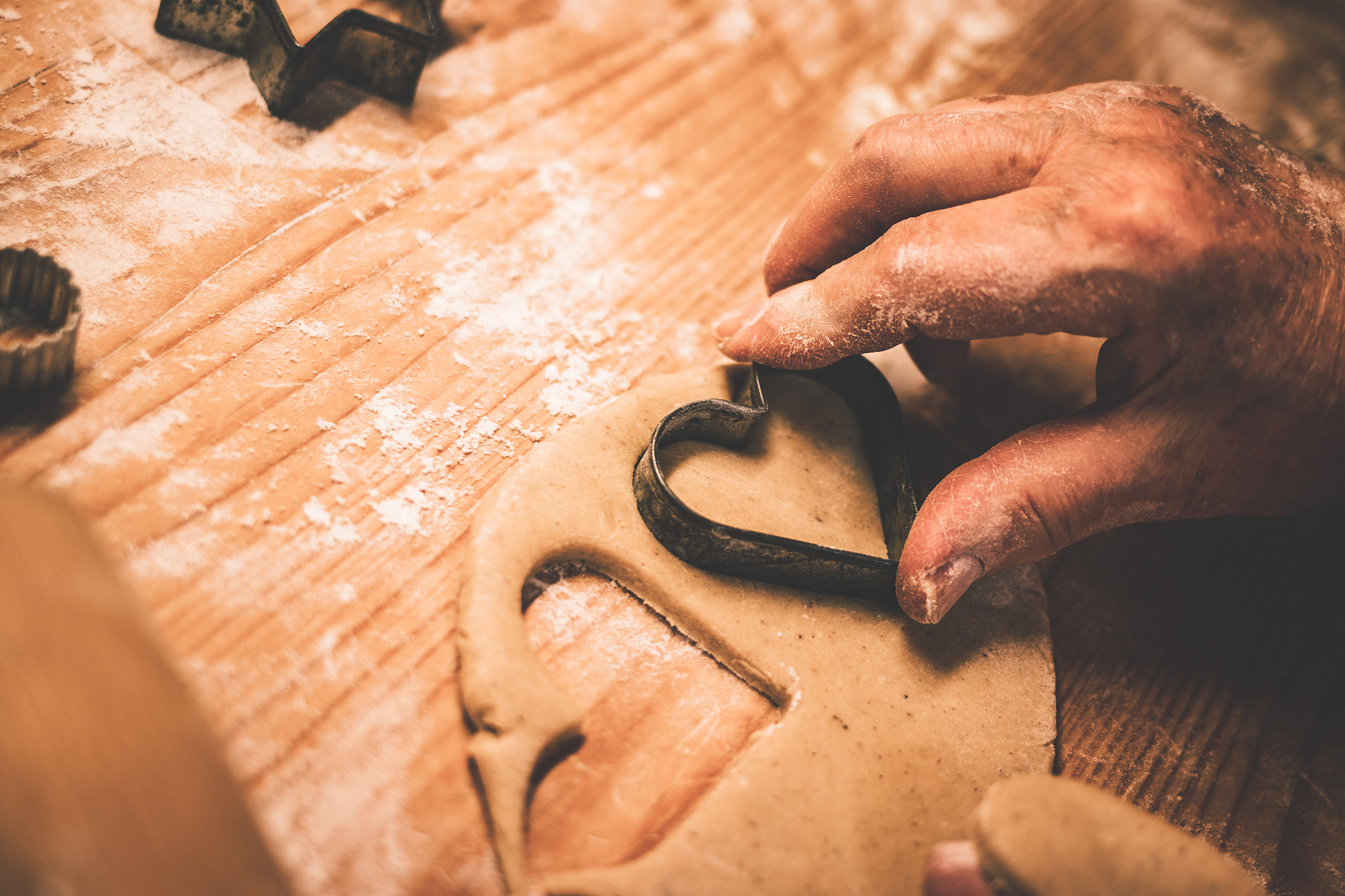 making gingerbread cookie, cutting heart shape from dough by coo