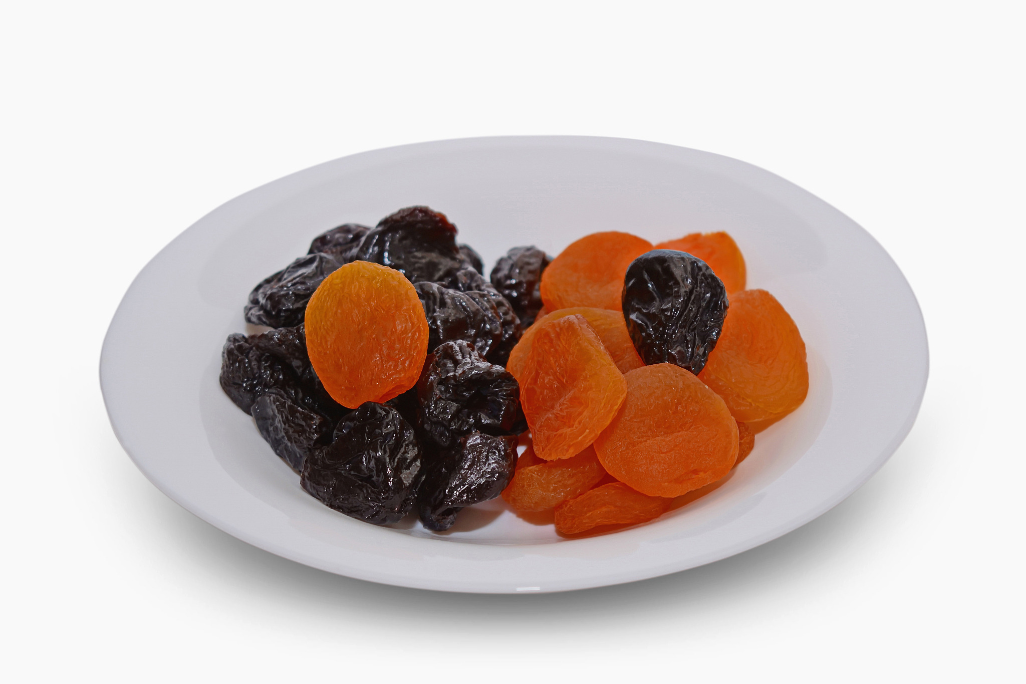 dried apricots and prunes on a white background.