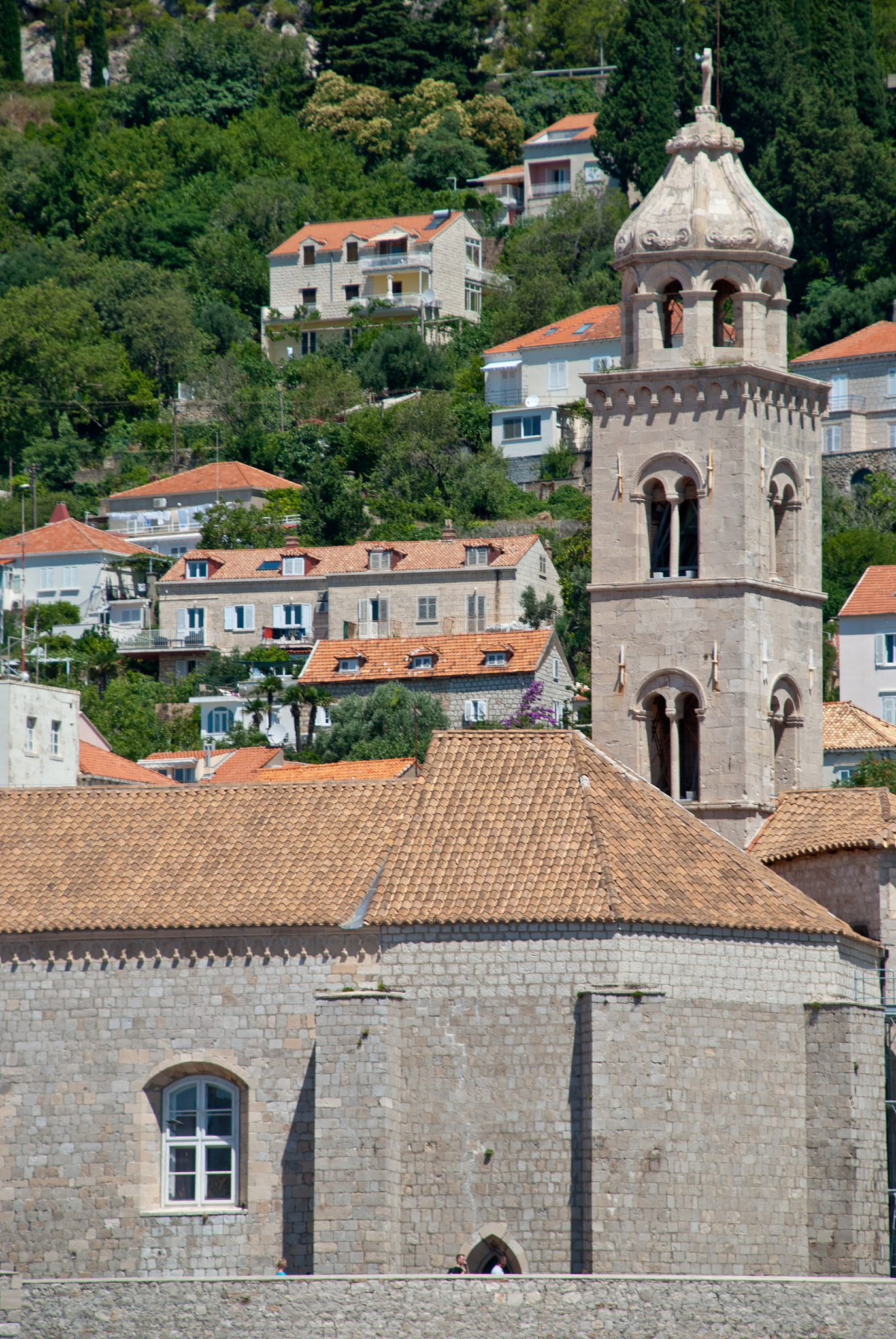 view of dominican monastery in dubrovnik with slim tower inside 