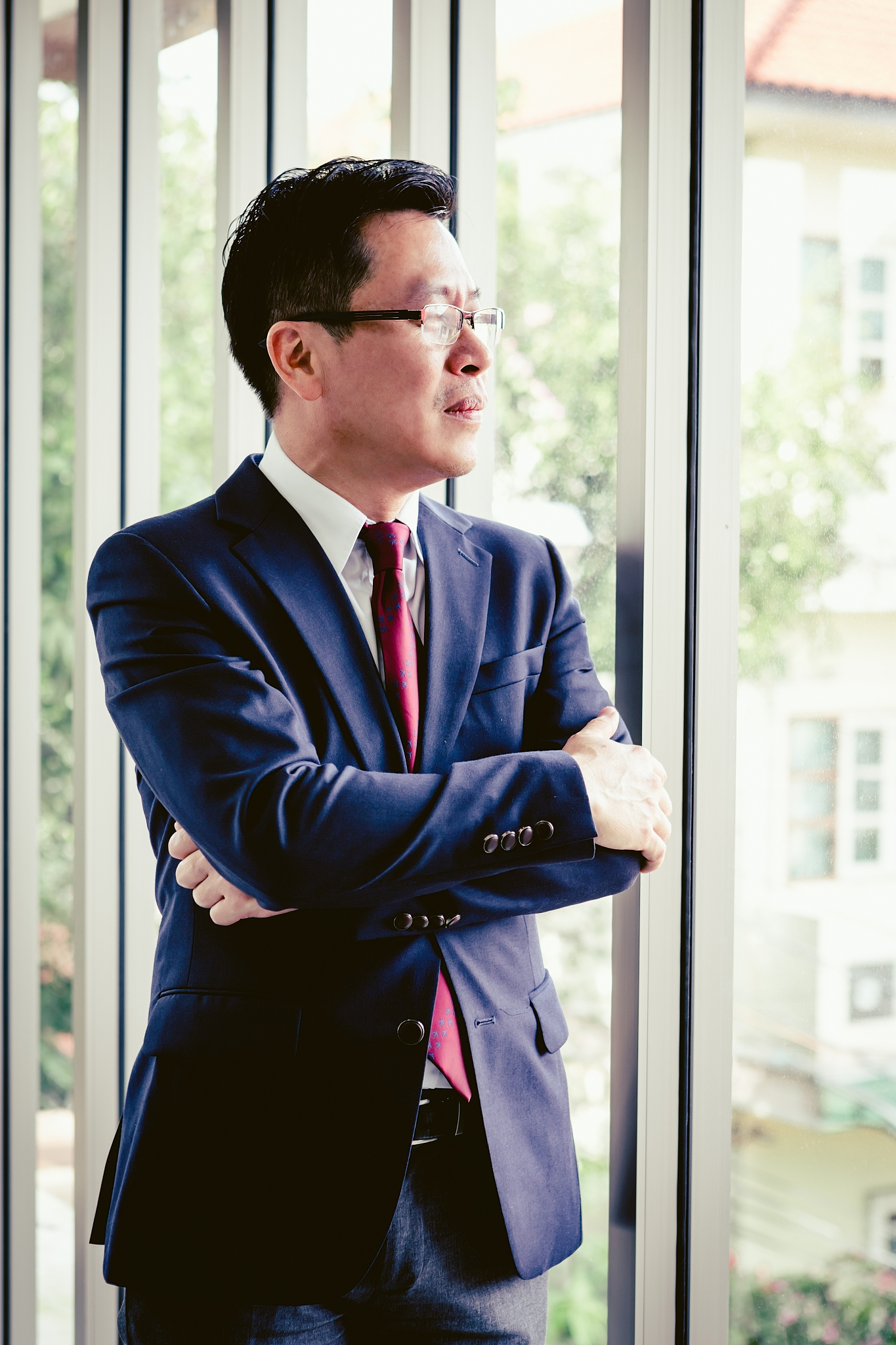 portrait business men wearing white suit standing looking out wi
