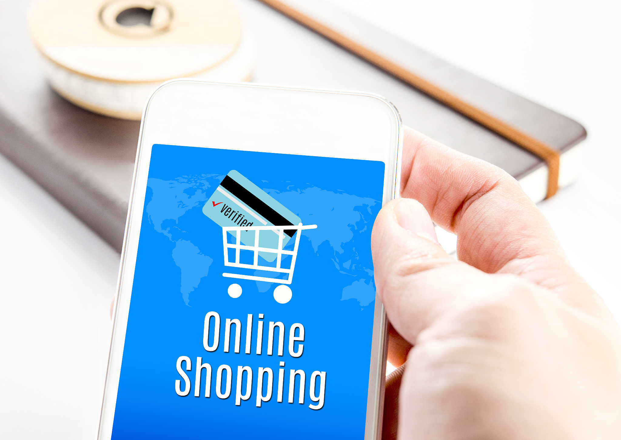 close up hand holding smartphone with online shopping word