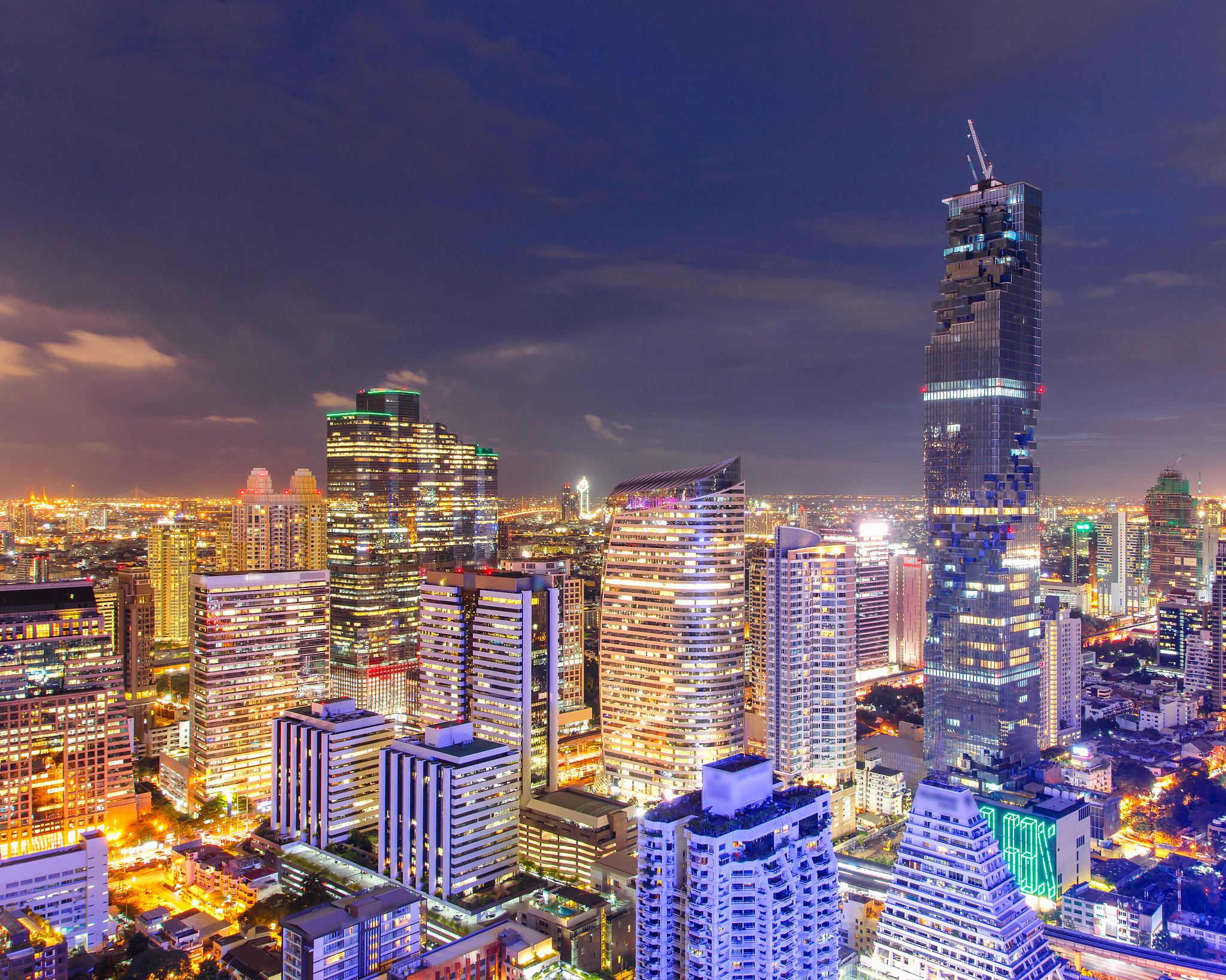 illuminated buildings in city against sky