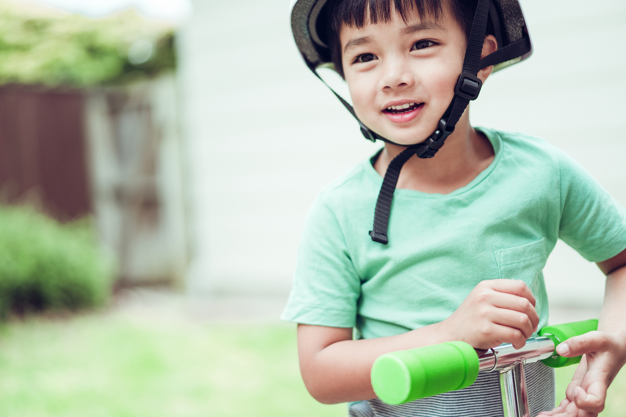 kid with safety gear on push scooter.