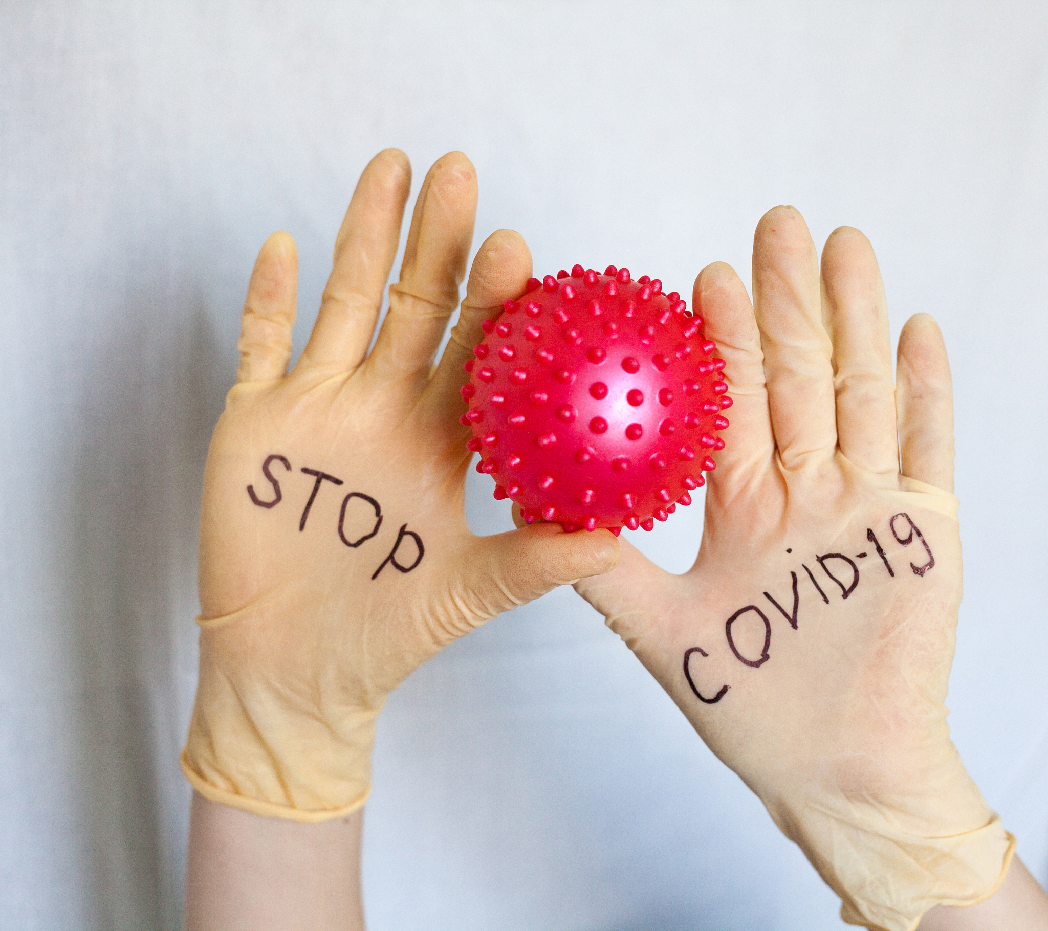 stop covid-19. text on medical gloves.