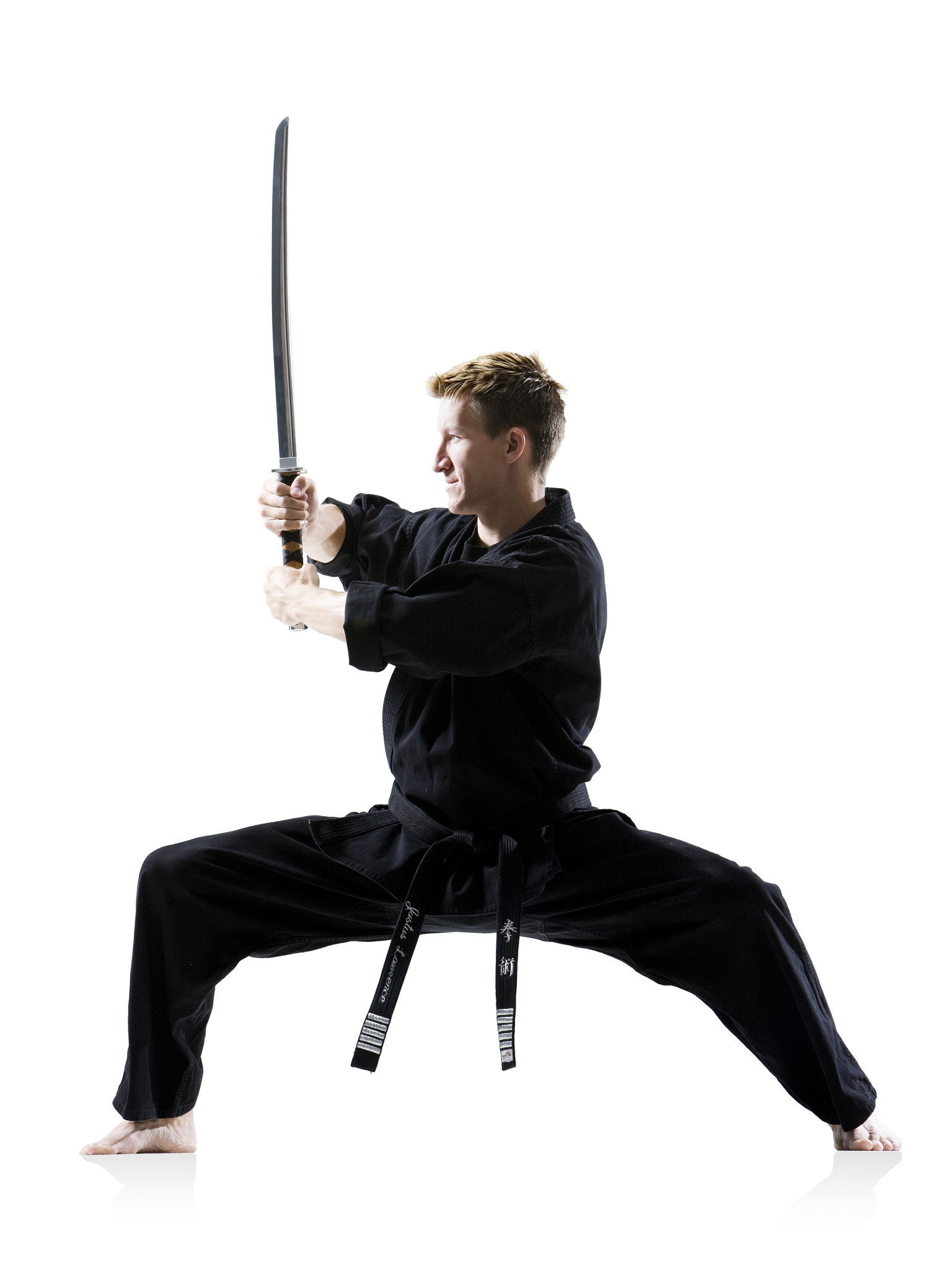 man in a black karate gi practicing martial arts