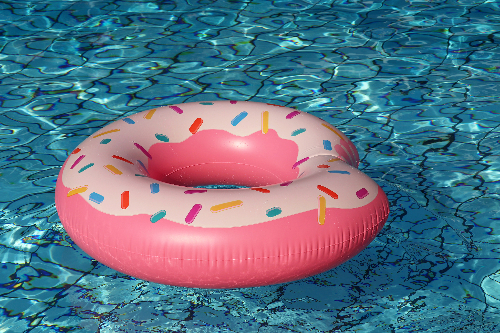 inflatable ring in donut shape in a clear water of swimming pool