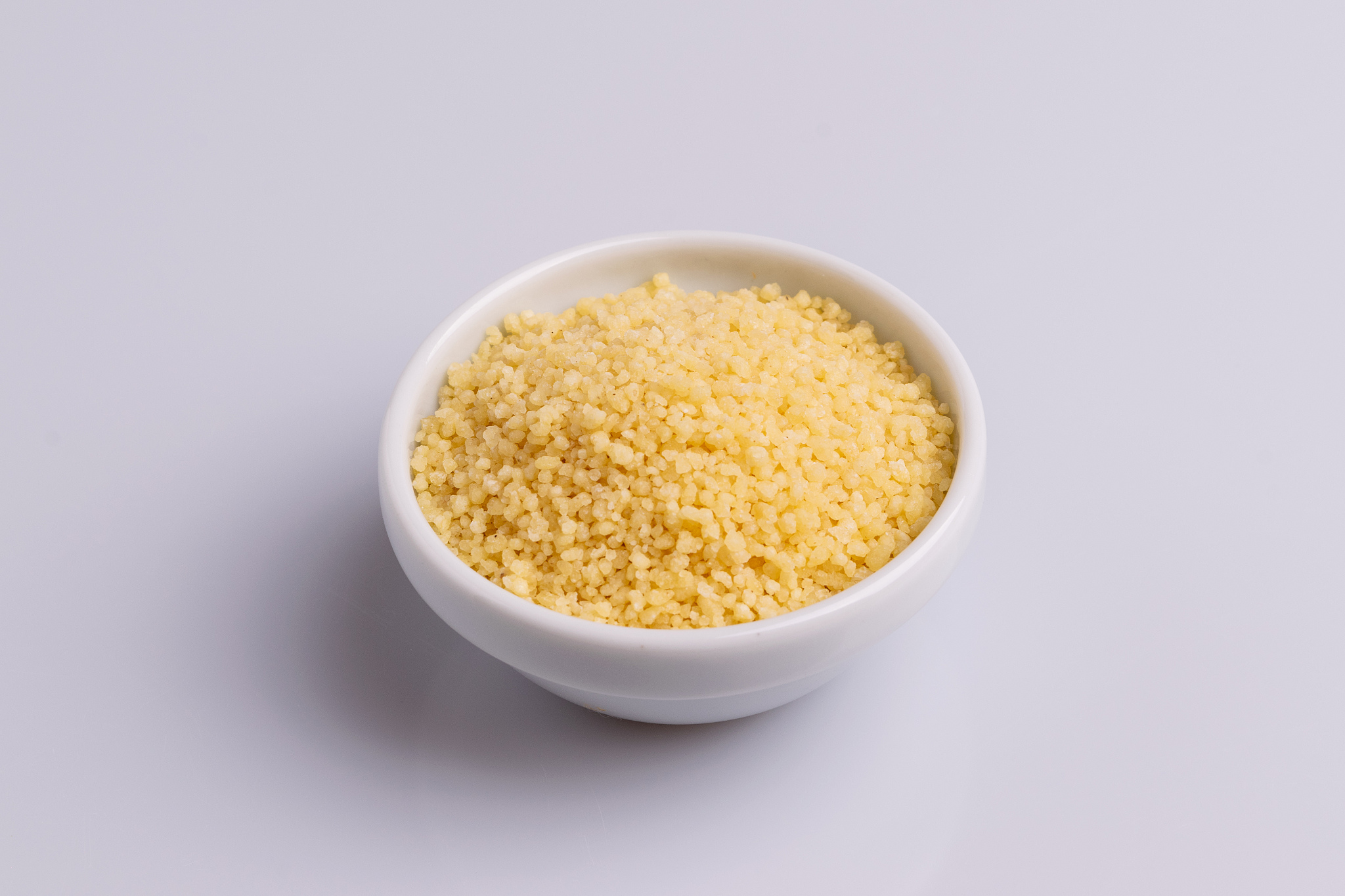 dry couscous isolated on white background, soft light, copy spac