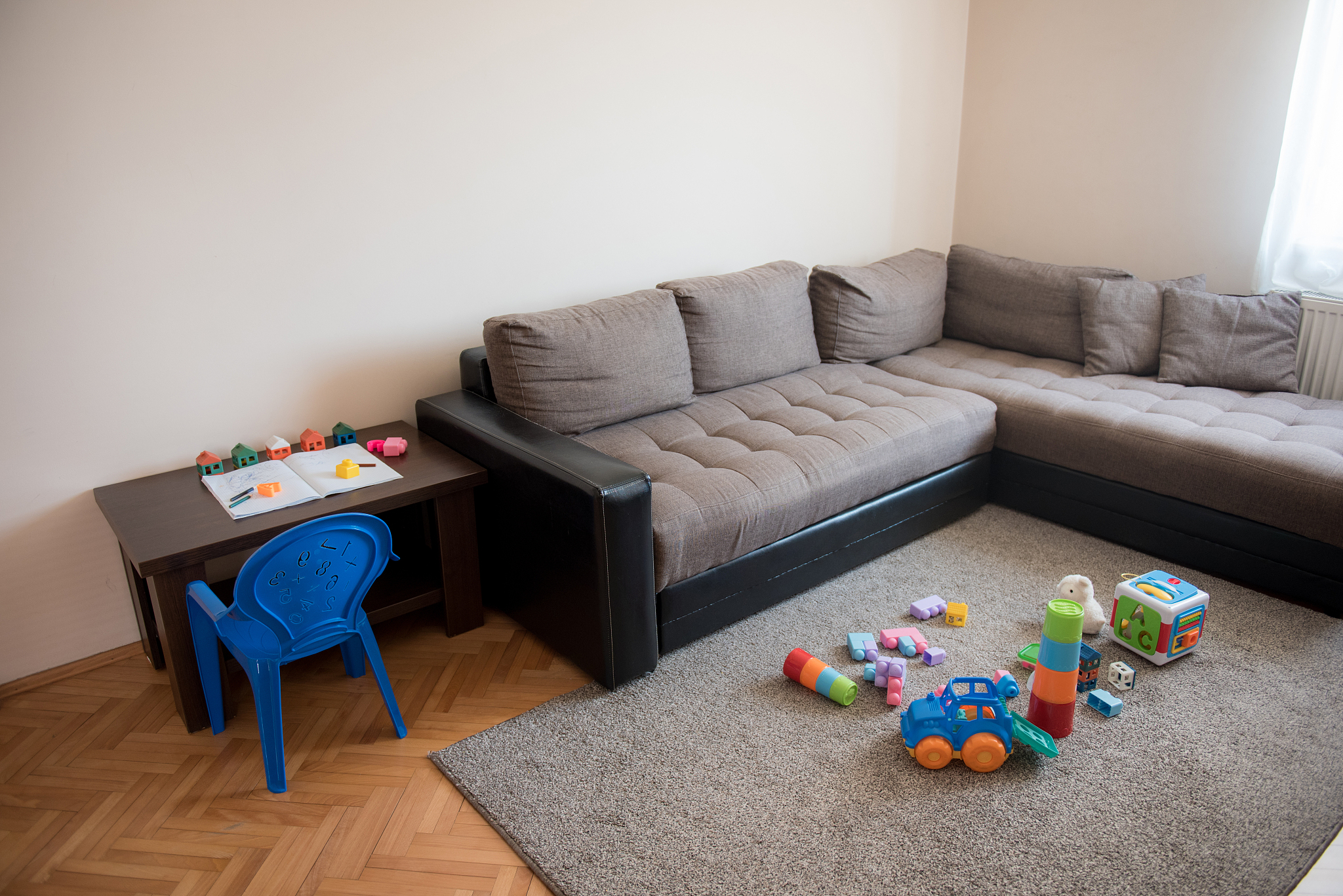 children toys left around living room after playing