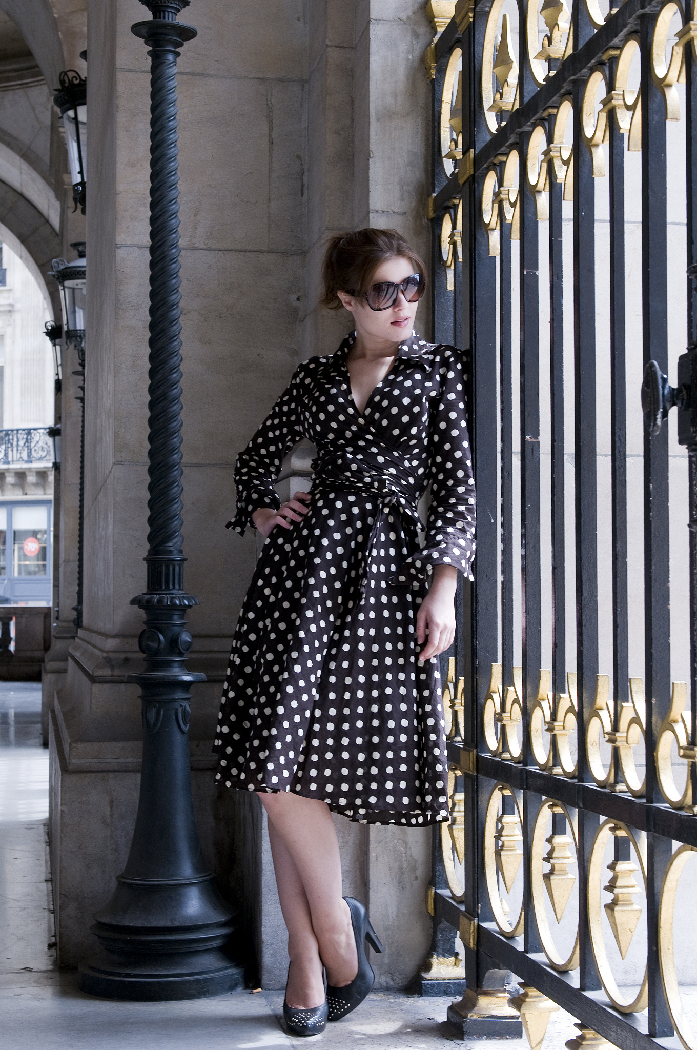 young woman looking through gate