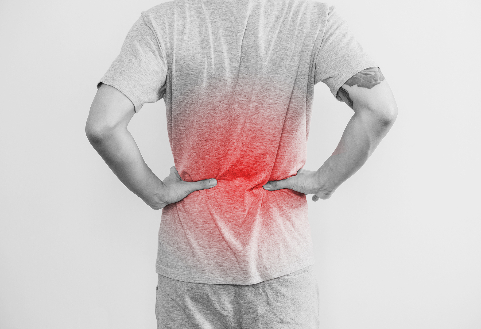 a man touching his back, with red highlight. back pain, backache