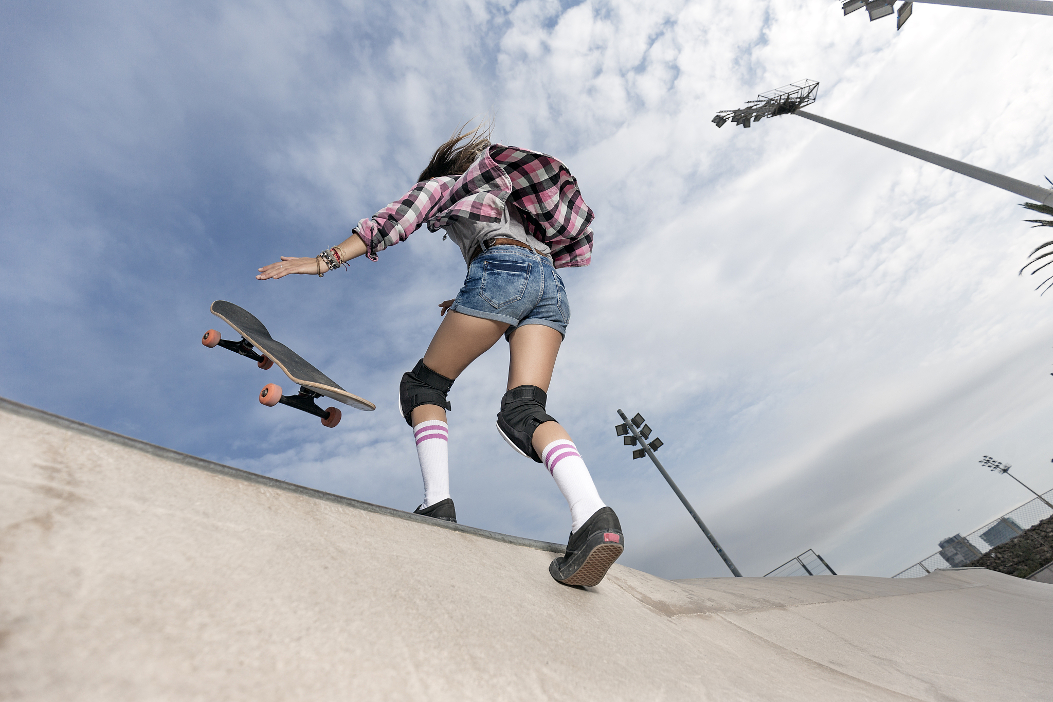 young woman skating in skateboard park