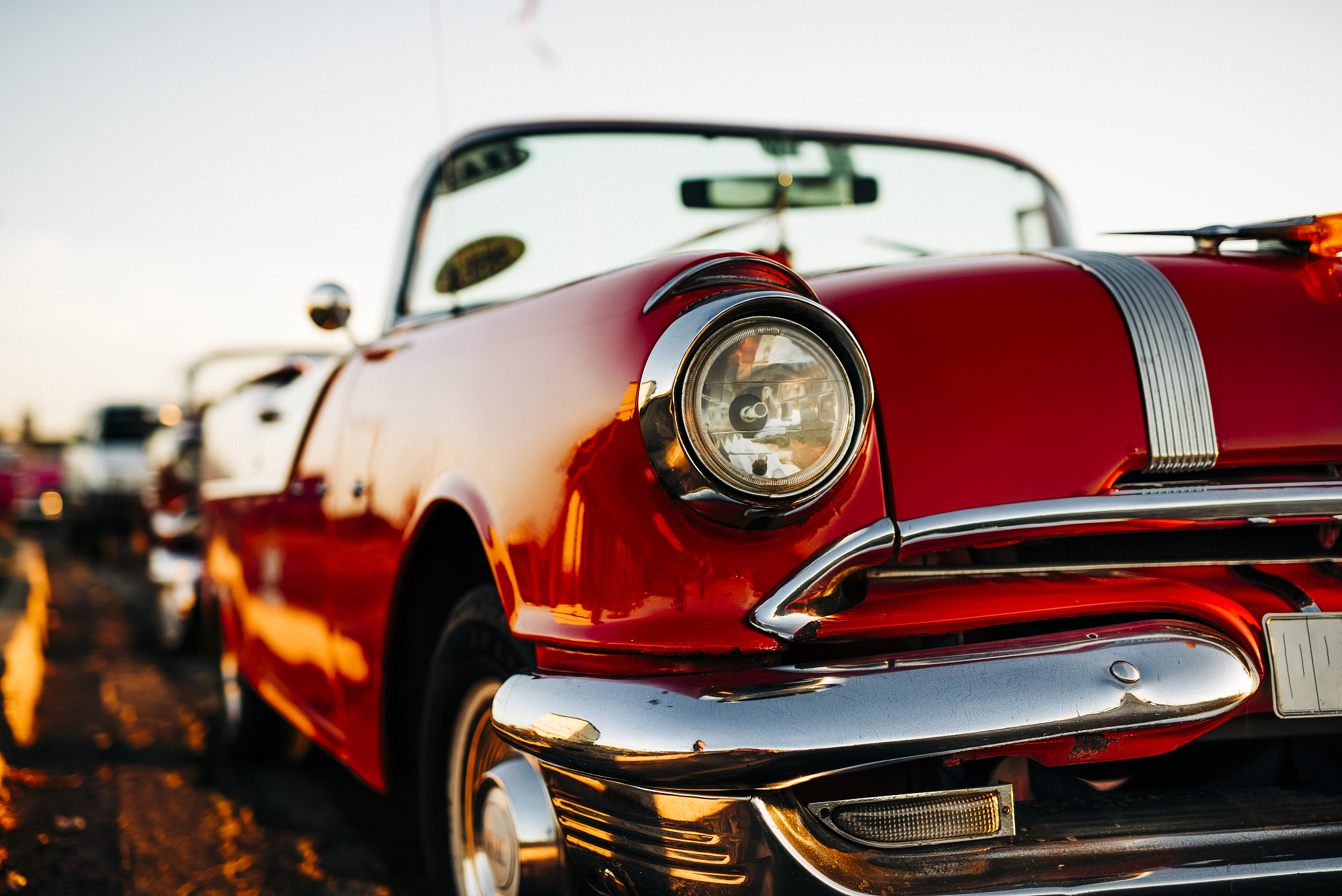 part of a red 1950's classic car, in havana, cuba, close-up